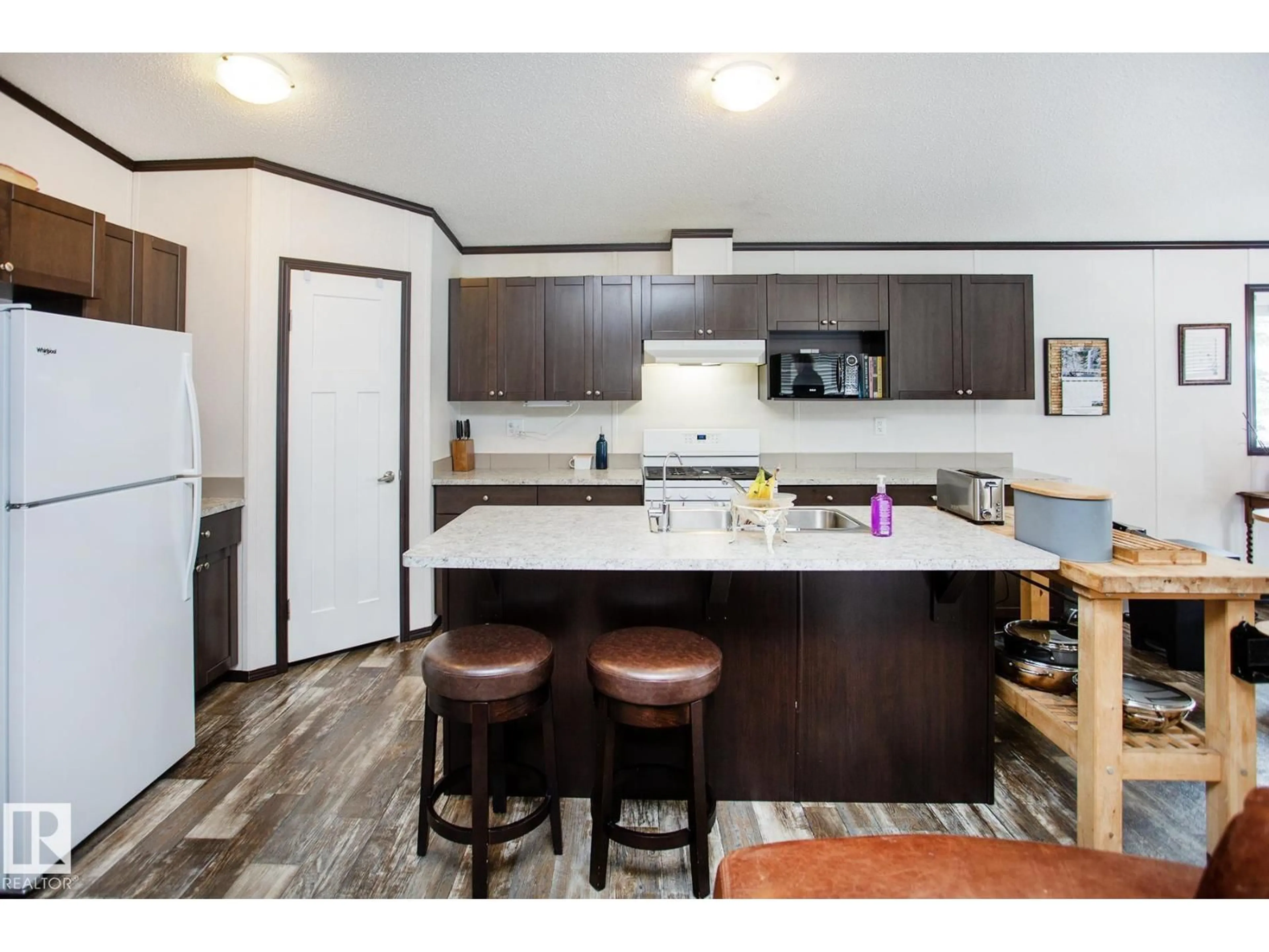 Open concept kitchen, wood/laminate floor for 56025 RGE ROAD 241, Rural Sturgeon County Alberta T0A0K0