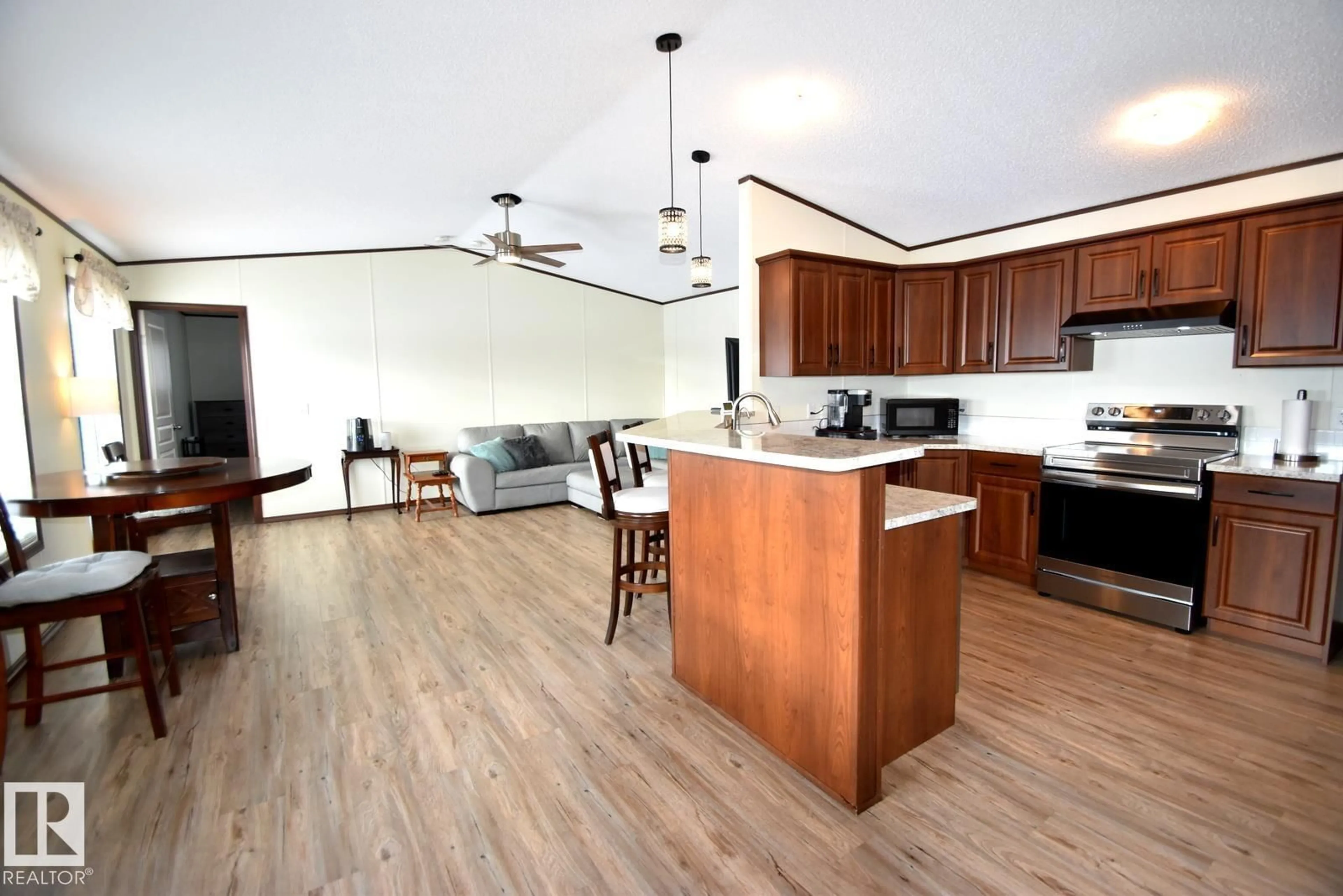 Open concept kitchen, wood/laminate floor for 529 - 13221 TWP RD 680, Rural Lac La Biche County Alberta T0A2C1