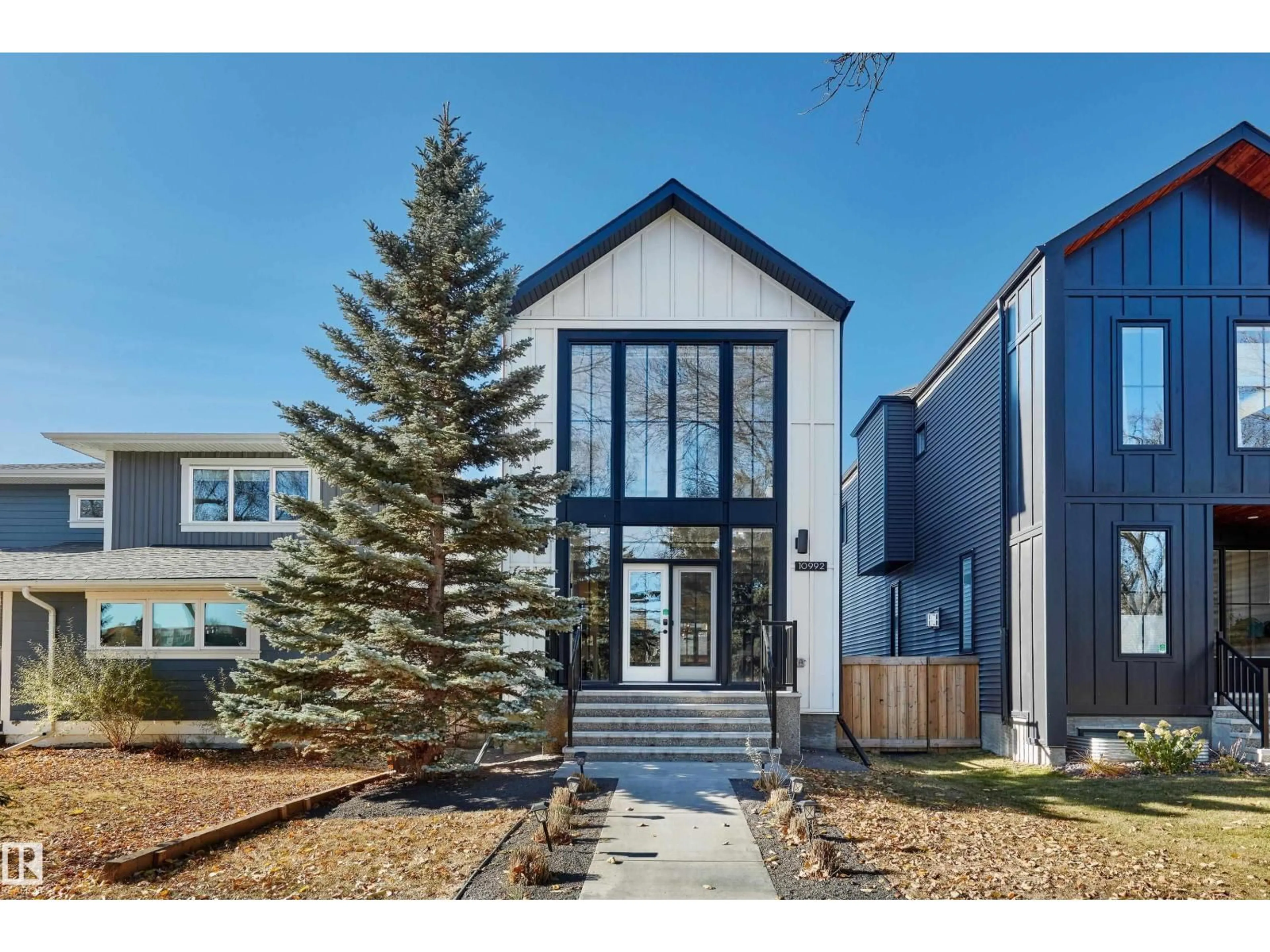 Home with vinyl exterior material, street for 10992 128 ST, Edmonton Alberta T5M0W4