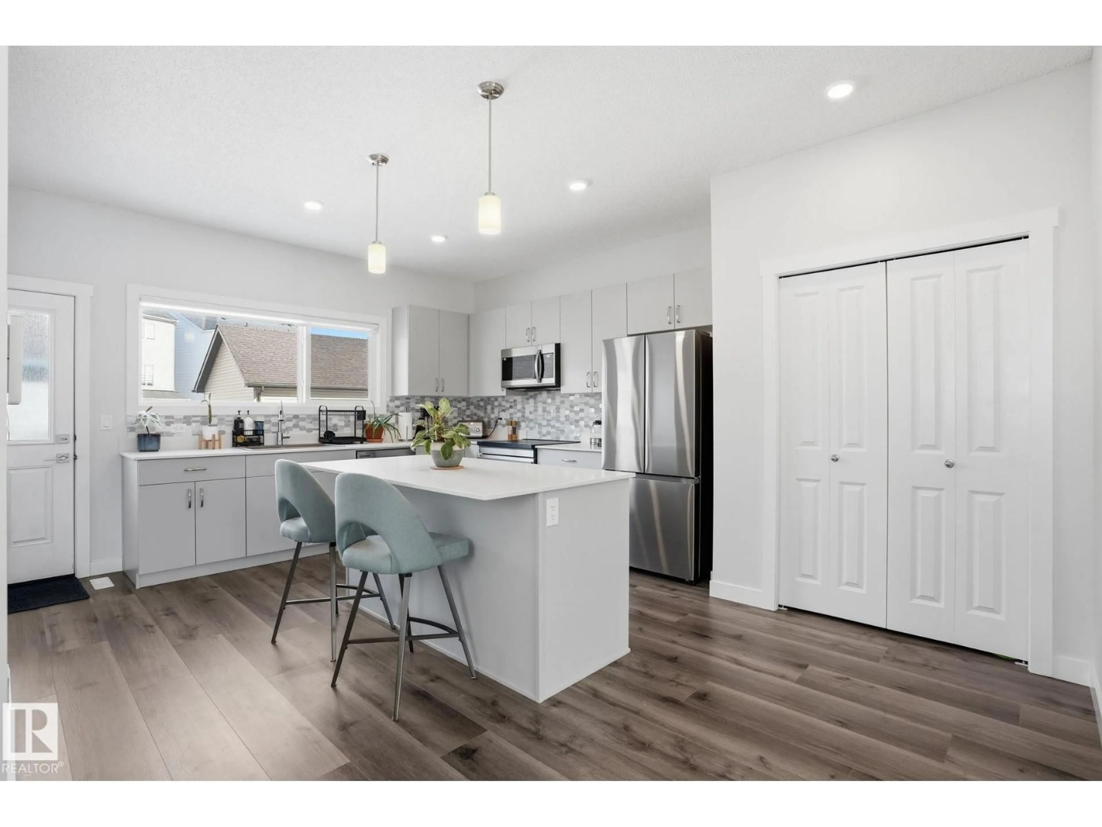 Open concept kitchen, wood/laminate floor for NE - 648 174 AV, Edmonton Alberta T5Y4E9
