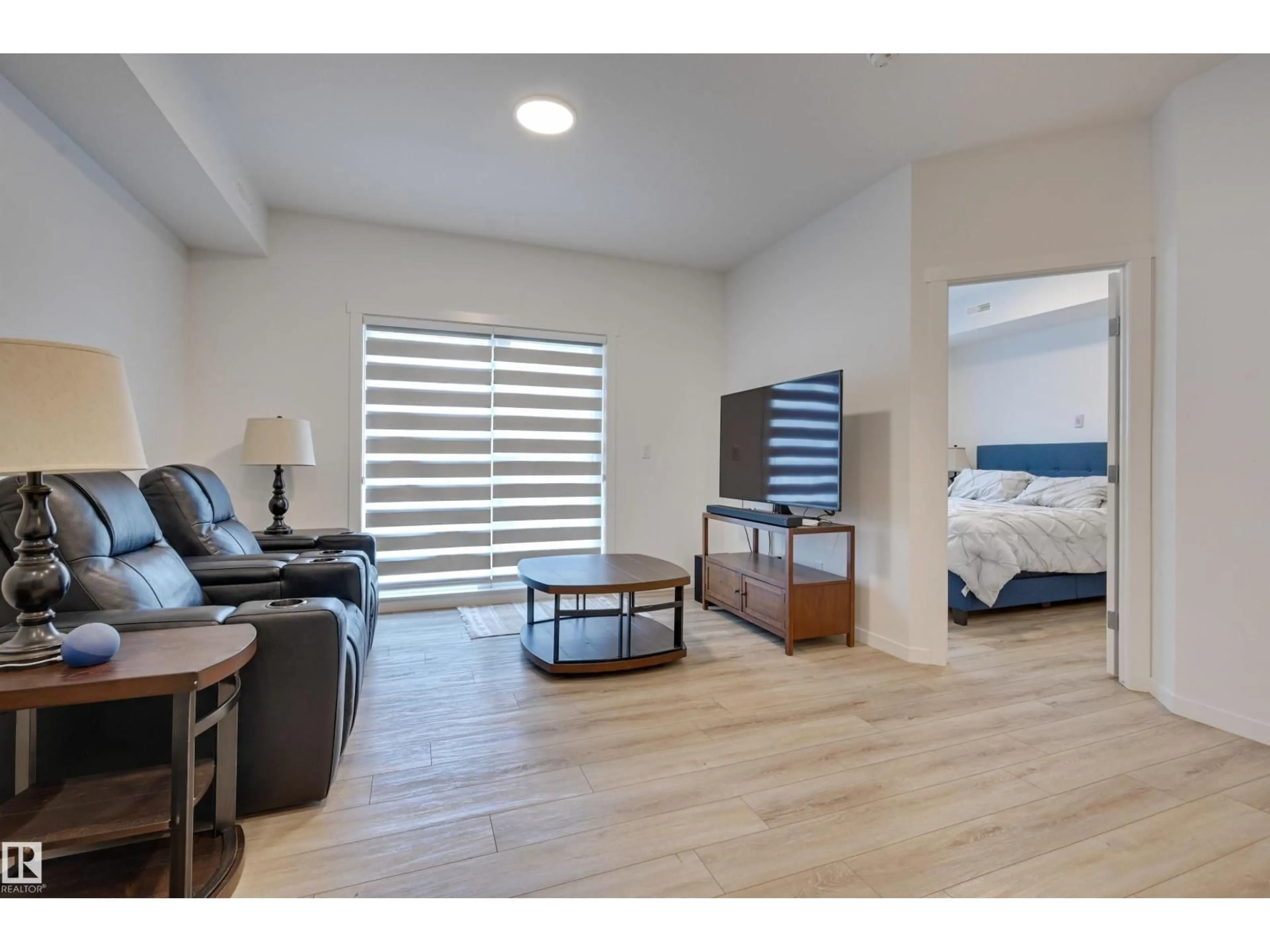 Living room with furniture, wood/laminate floor for 104 - 104 SECORD BV, Edmonton Alberta T5T7R9