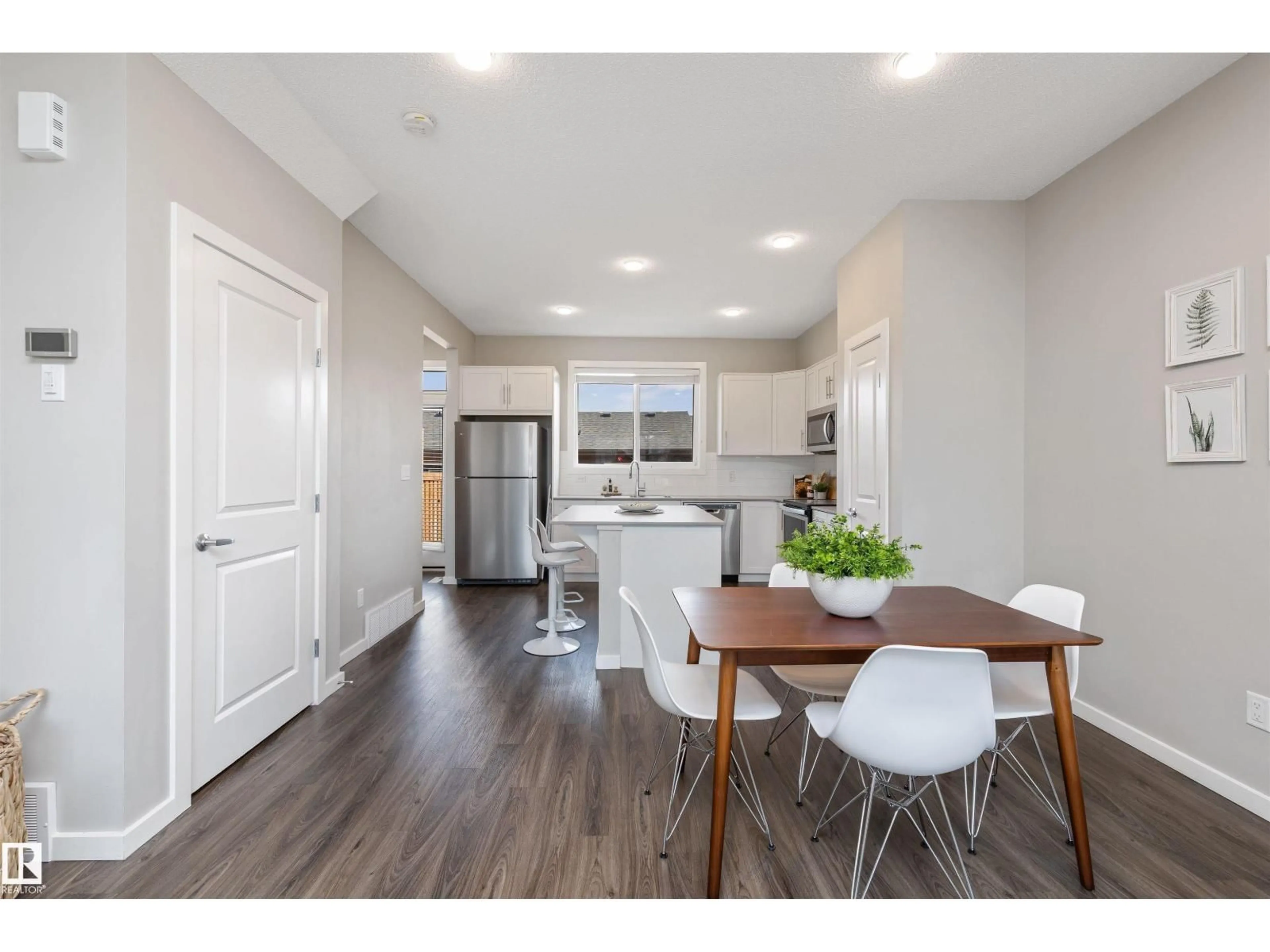 Open concept kitchen, wood/laminate floor for 1170 ROSENTHAL BV, Edmonton Alberta T5T7L3