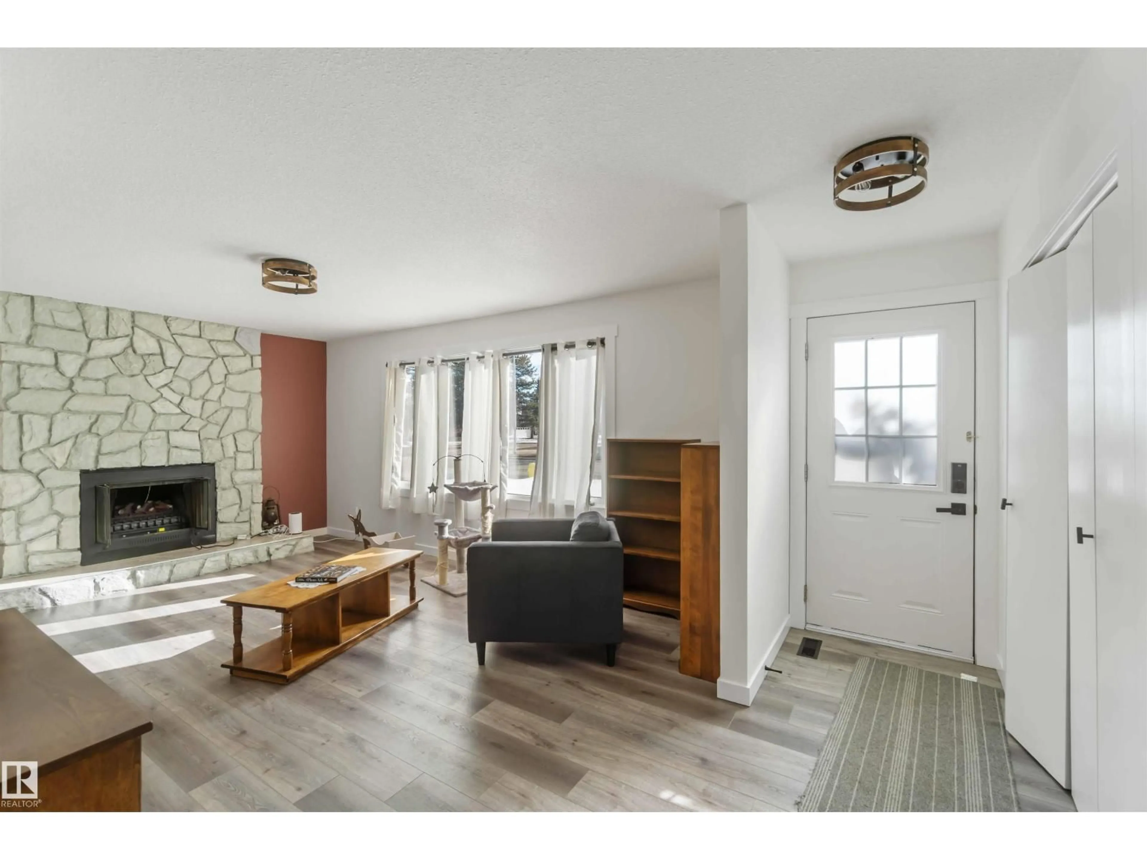 Living room with furniture, wood/laminate floor for 104 OAK DR, Wetaskiwin Alberta T9A2E7