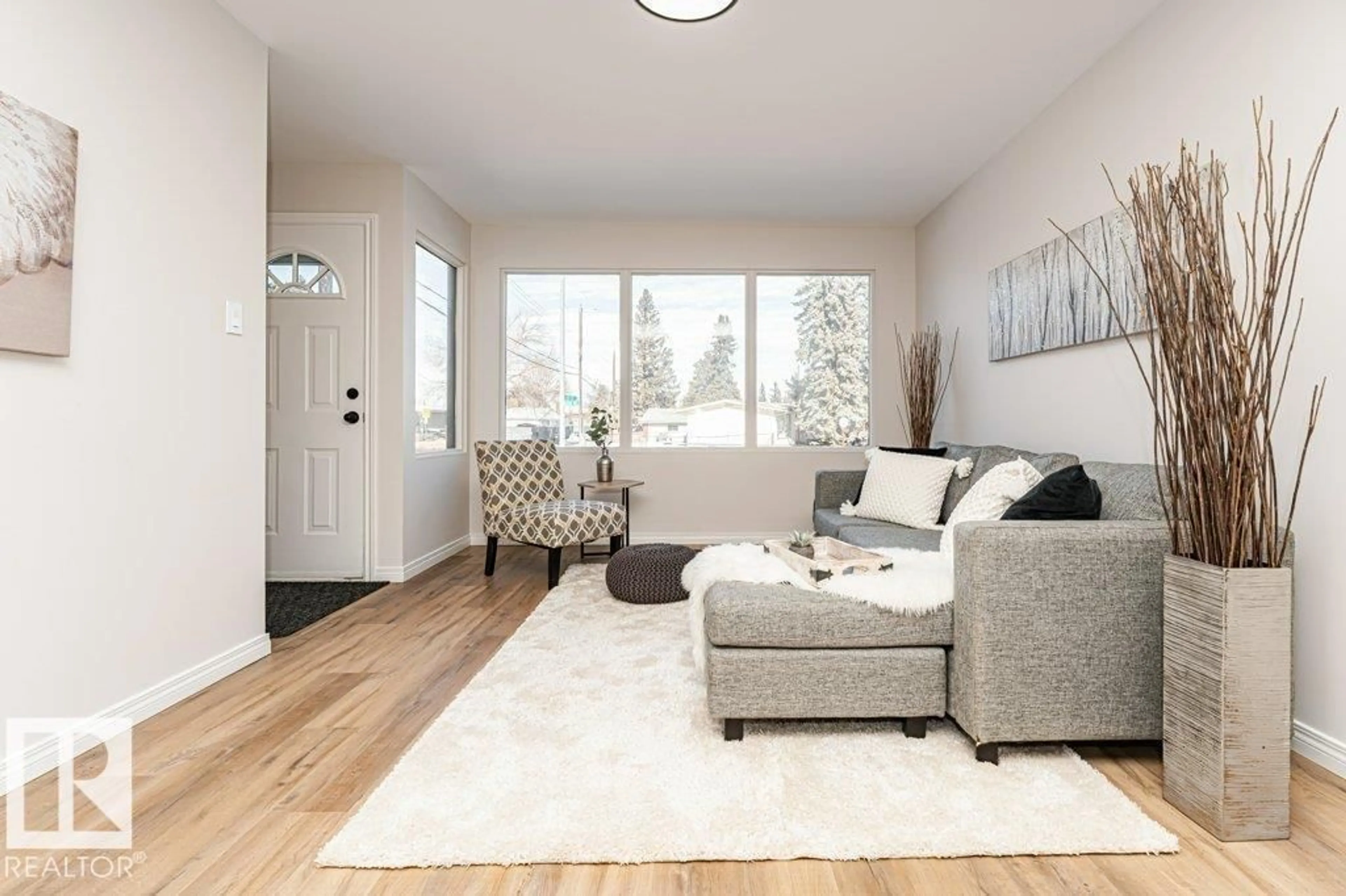 Living room with furniture, wood/laminate floor for NW - 12209A 134B AV, Edmonton Alberta T5L3W9