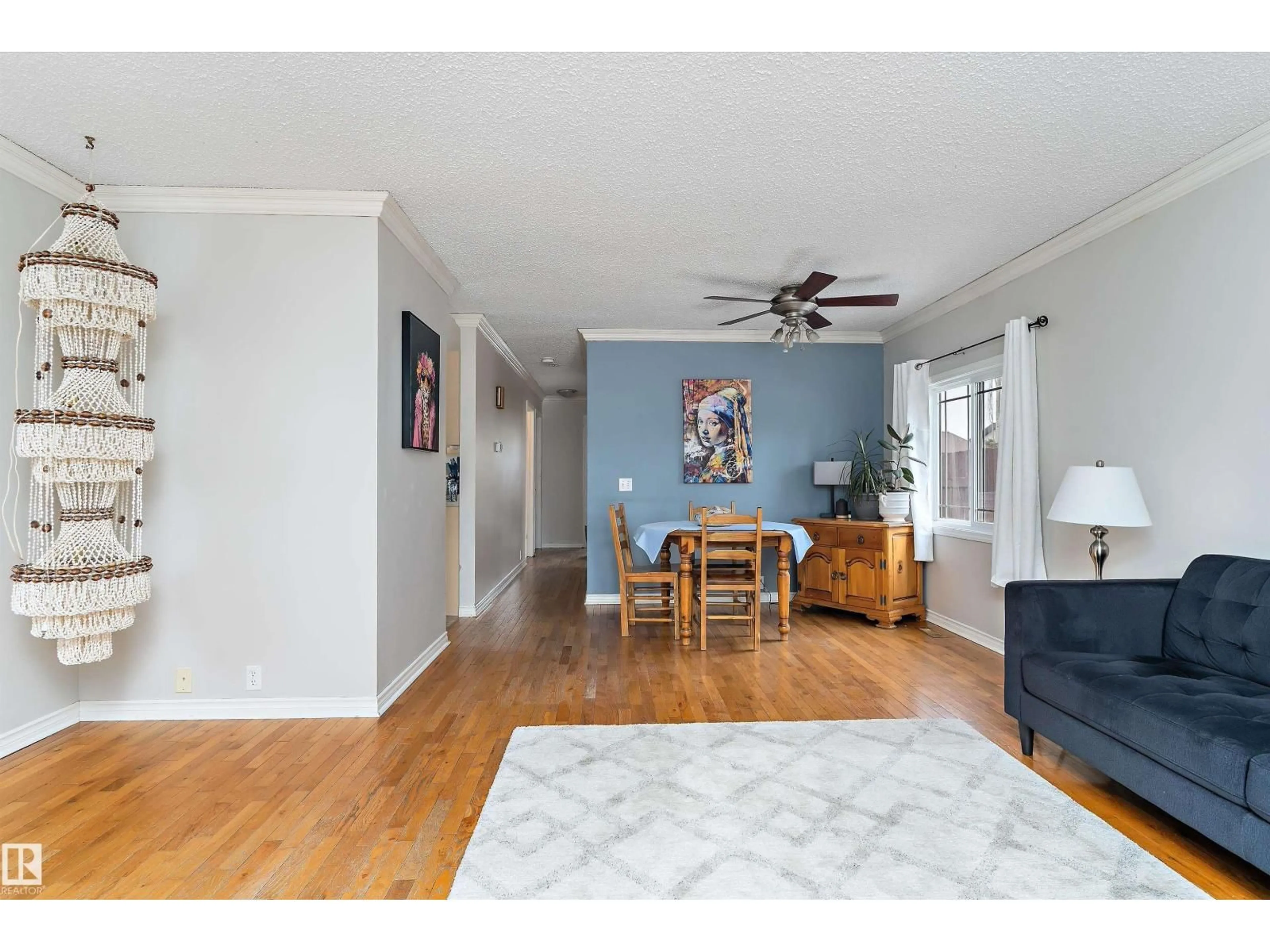 Living room with furniture, wood/laminate floor for 3536 12A AVE, Edmonton Alberta T6L3L5
