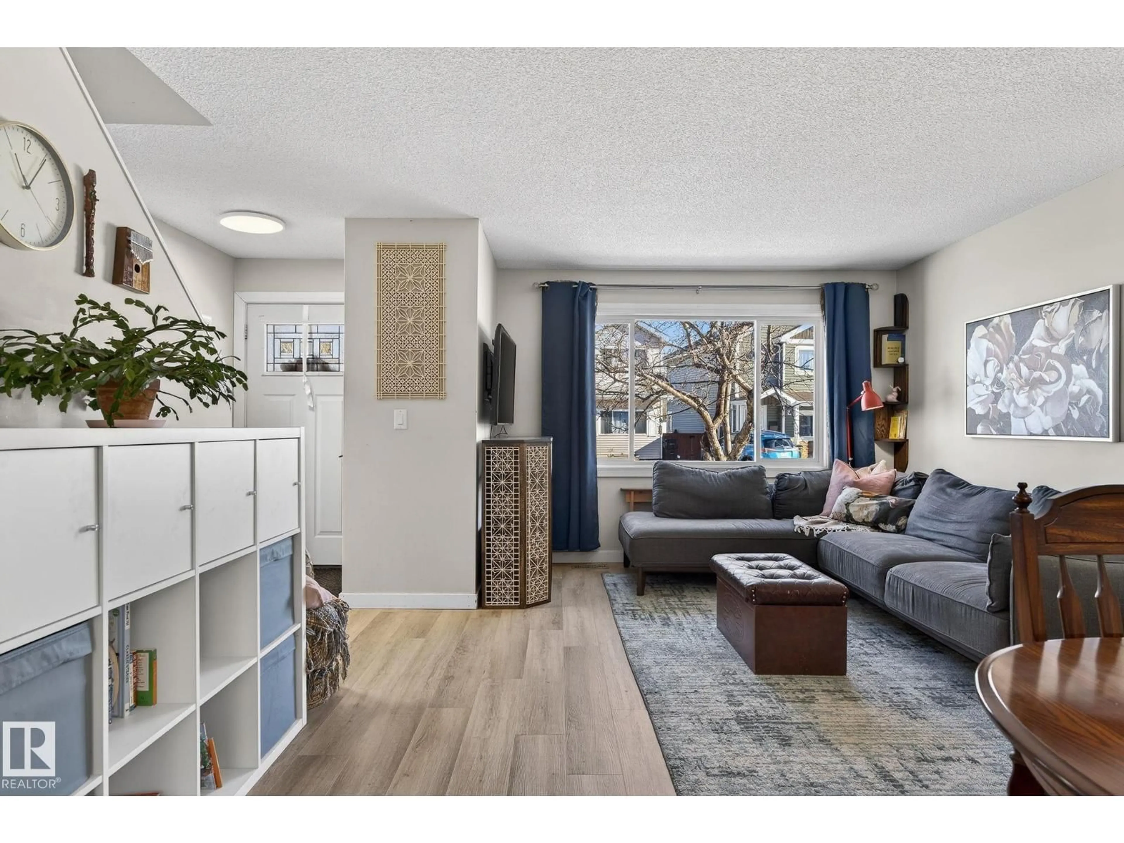 Living room with furniture, wood/laminate floor for 1873 151 AV, Edmonton Alberta T5Y1W1