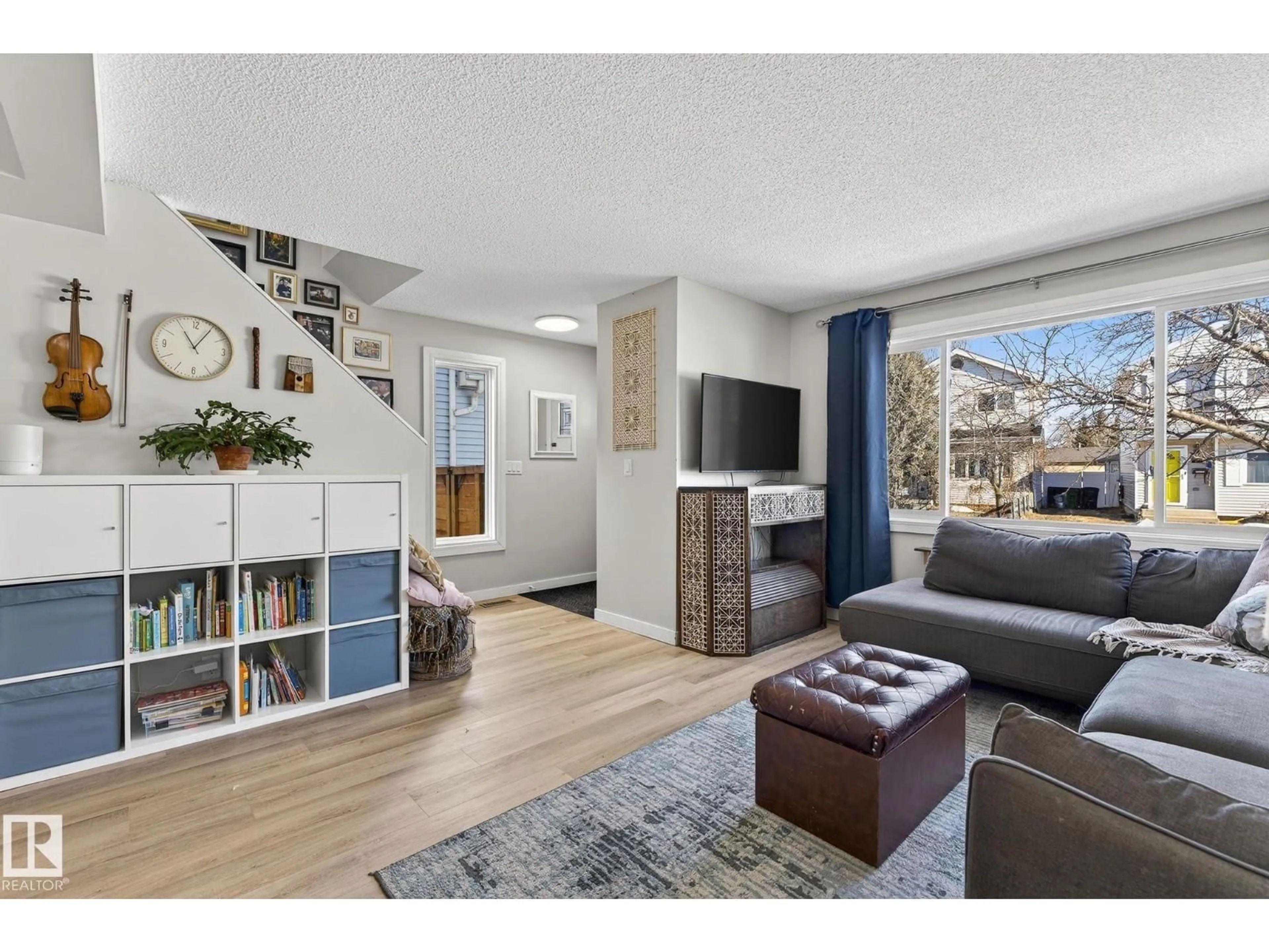 Living room with furniture, wood/laminate floor for 1873 151 AV, Edmonton Alberta T5Y1W1