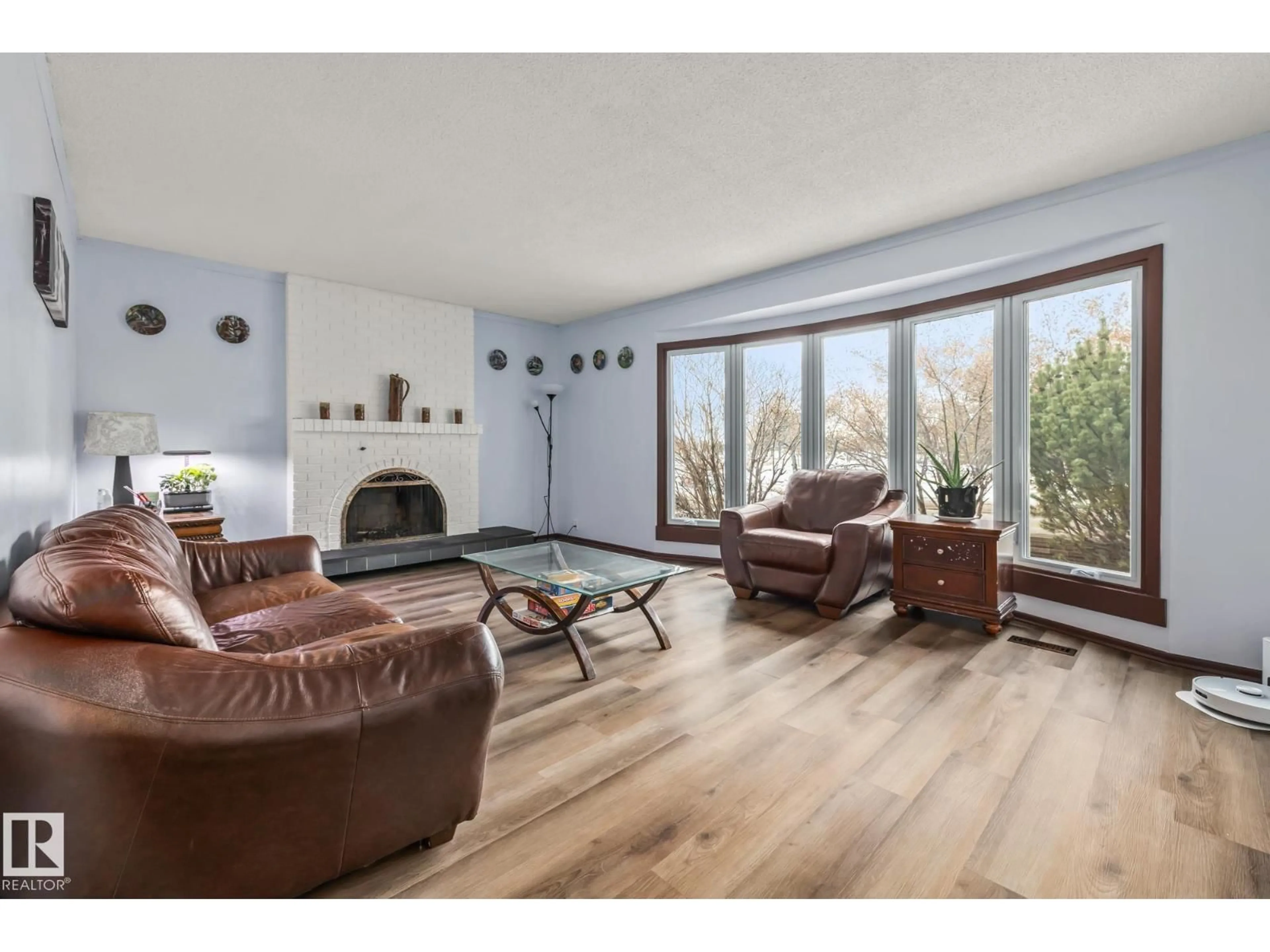 Living room with furniture, wood/laminate floor for 8812 135 AV, Edmonton Alberta T5E1N3