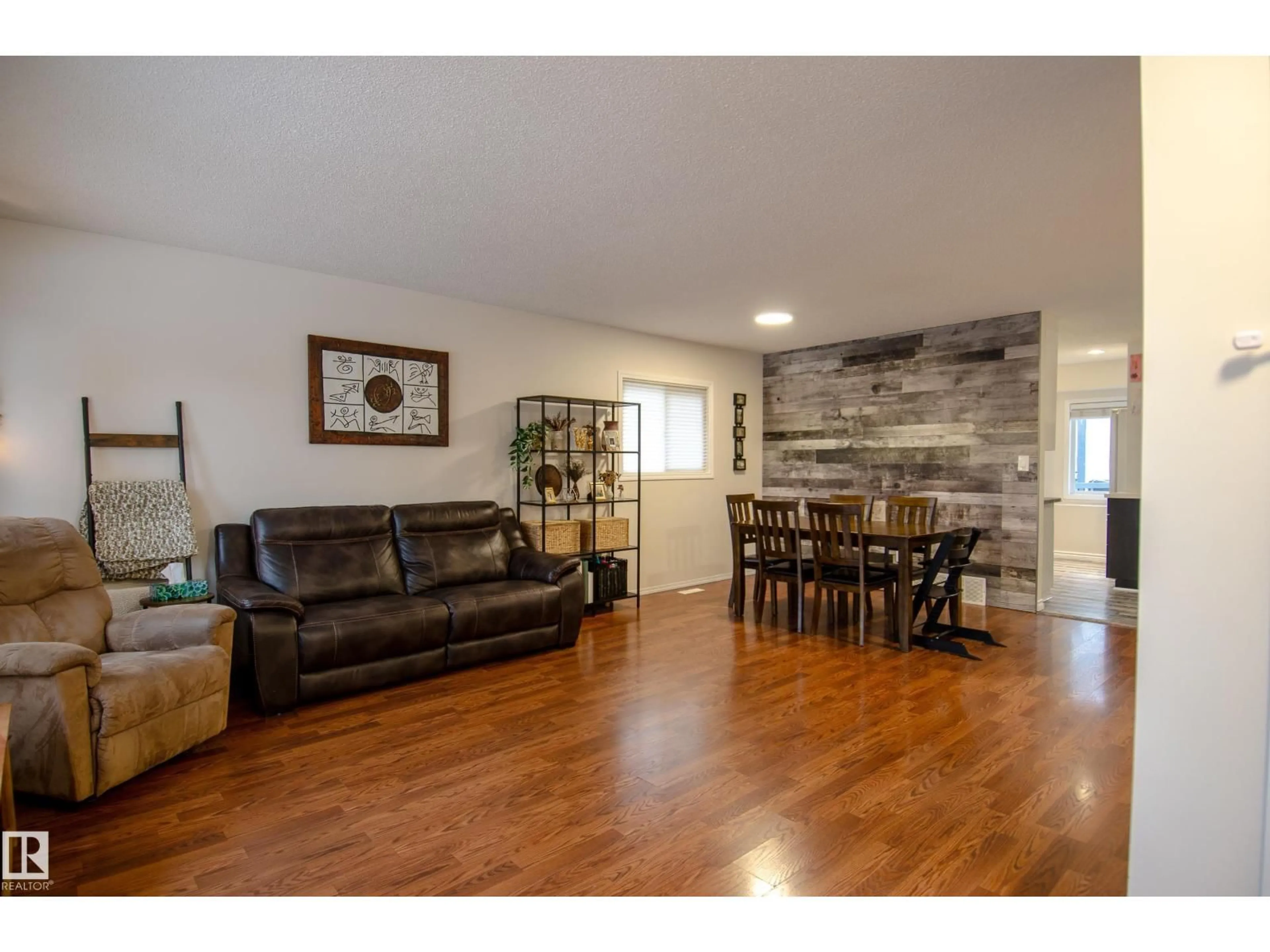 Living room with furniture, wood/laminate floor for 3516 13 AV, Edmonton Alberta T6L3B3