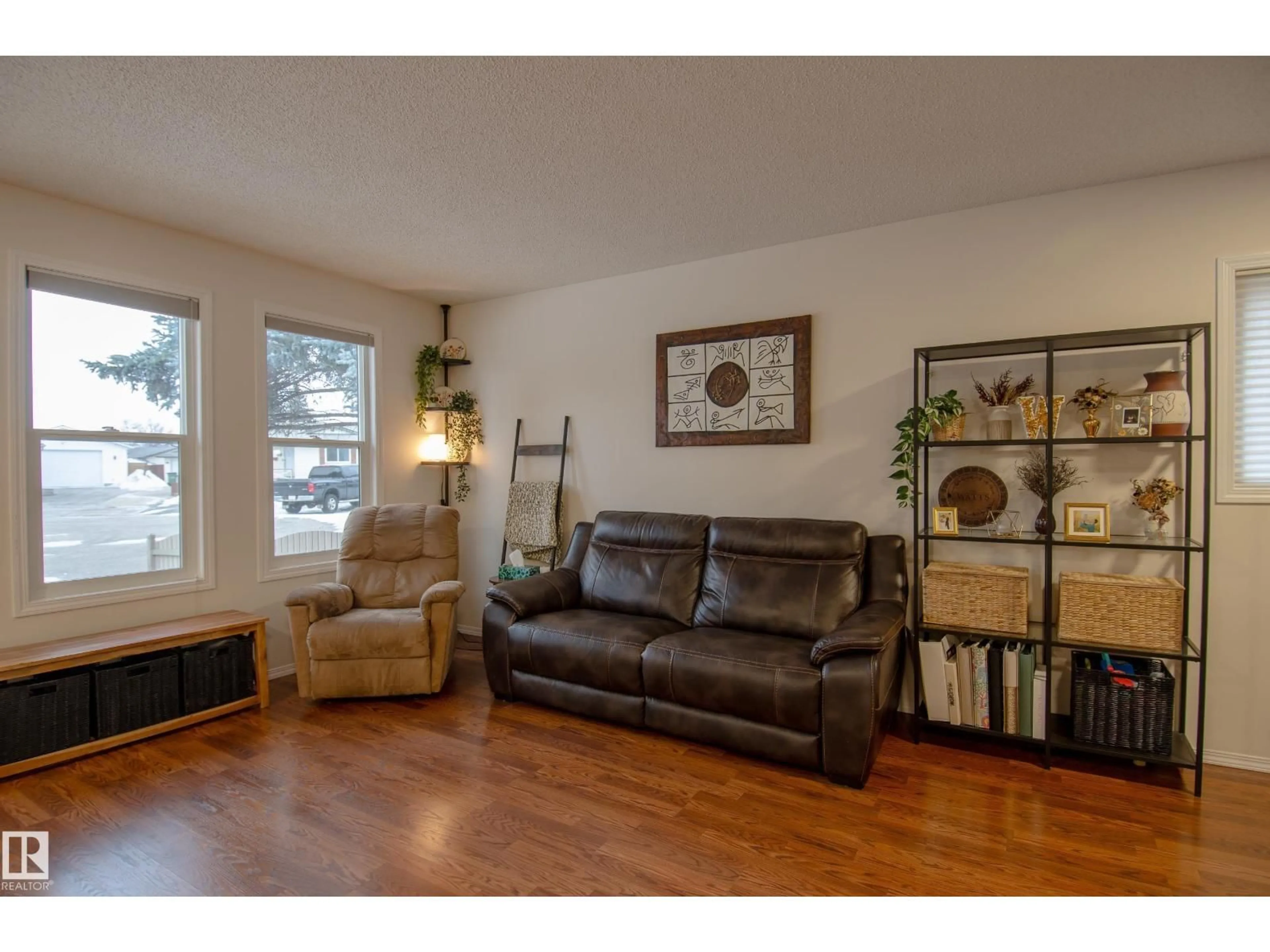 Living room with furniture, wood/laminate floor for 3516 13 AV, Edmonton Alberta T6L3B3