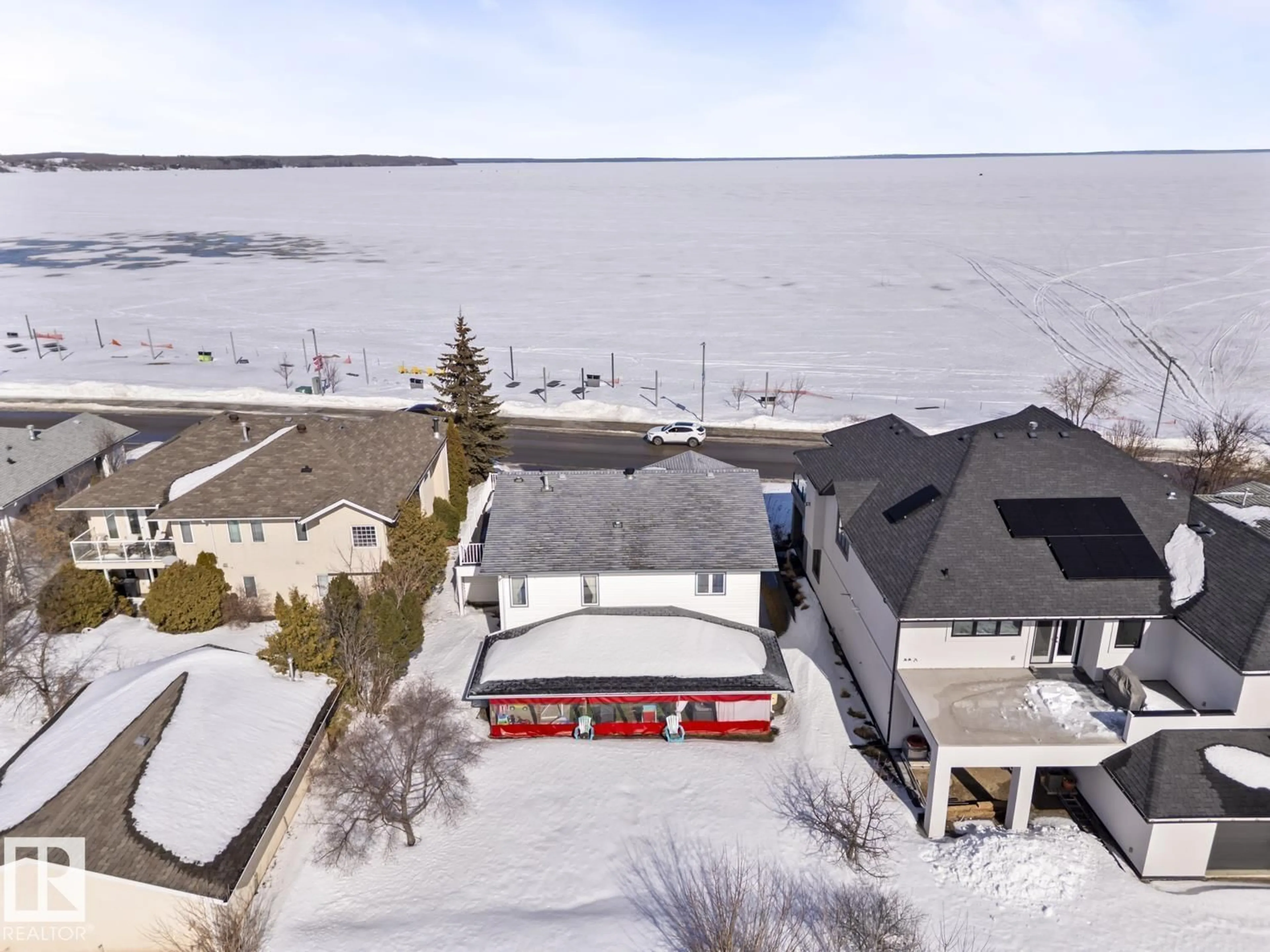 A pic from outside/outdoor area/front of a property/back of a property/a pic from drone, water/lake/river/ocean view for 1805 1 AV, Cold Lake Alberta T9M1B5