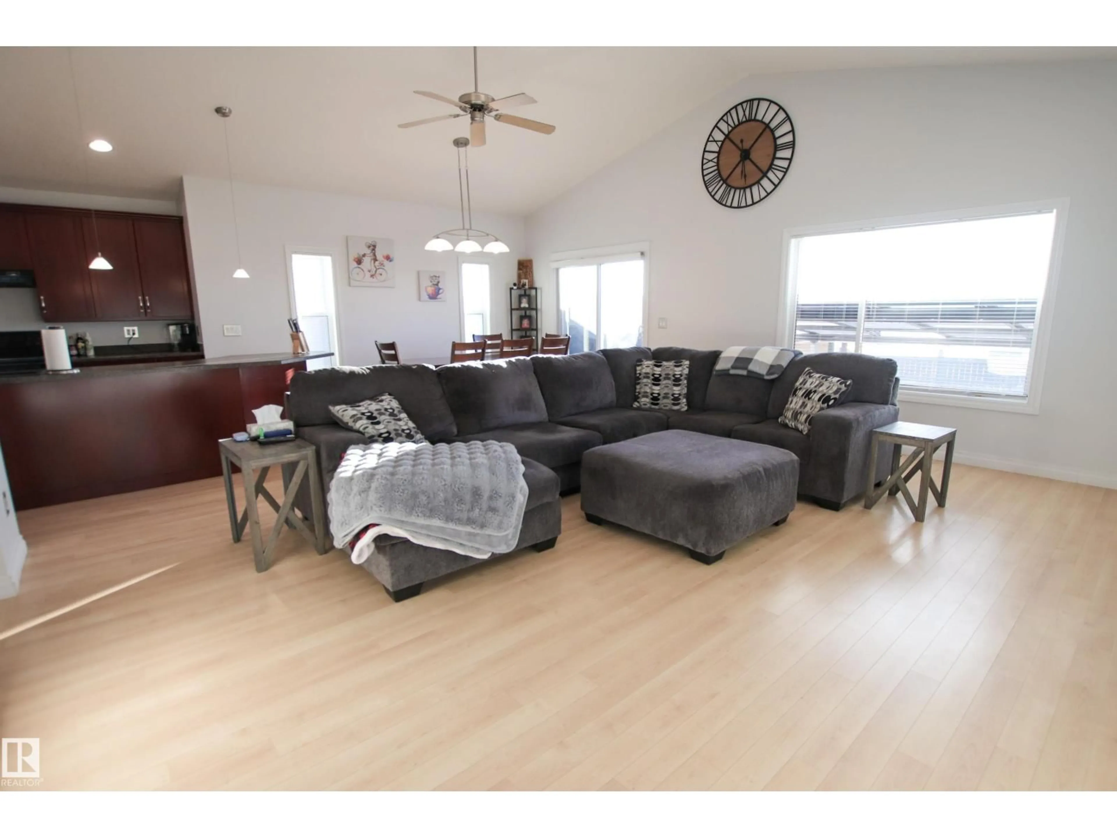 Living room with furniture, wood/laminate floor for 112 HOULE DR, Morinville Alberta T8R0E1