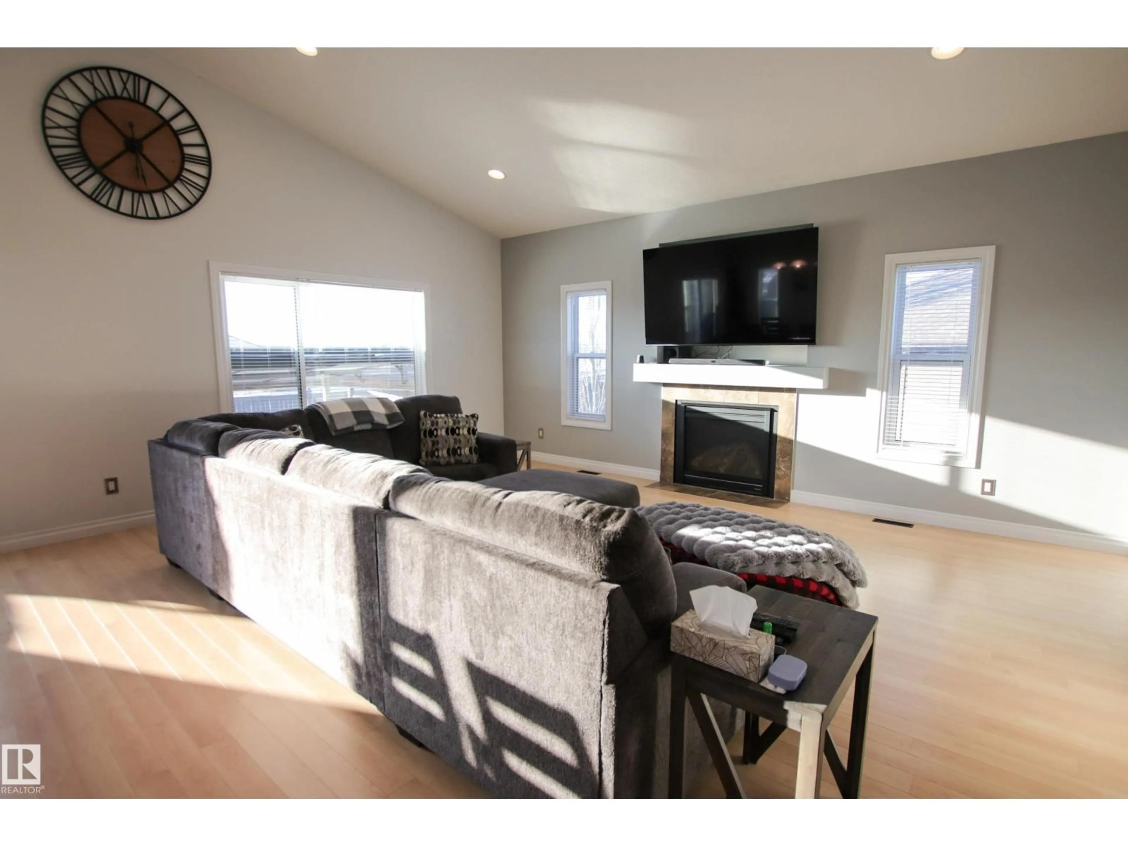 Living room with furniture, wood/laminate floor for 112 HOULE DR, Morinville Alberta T8R0E1