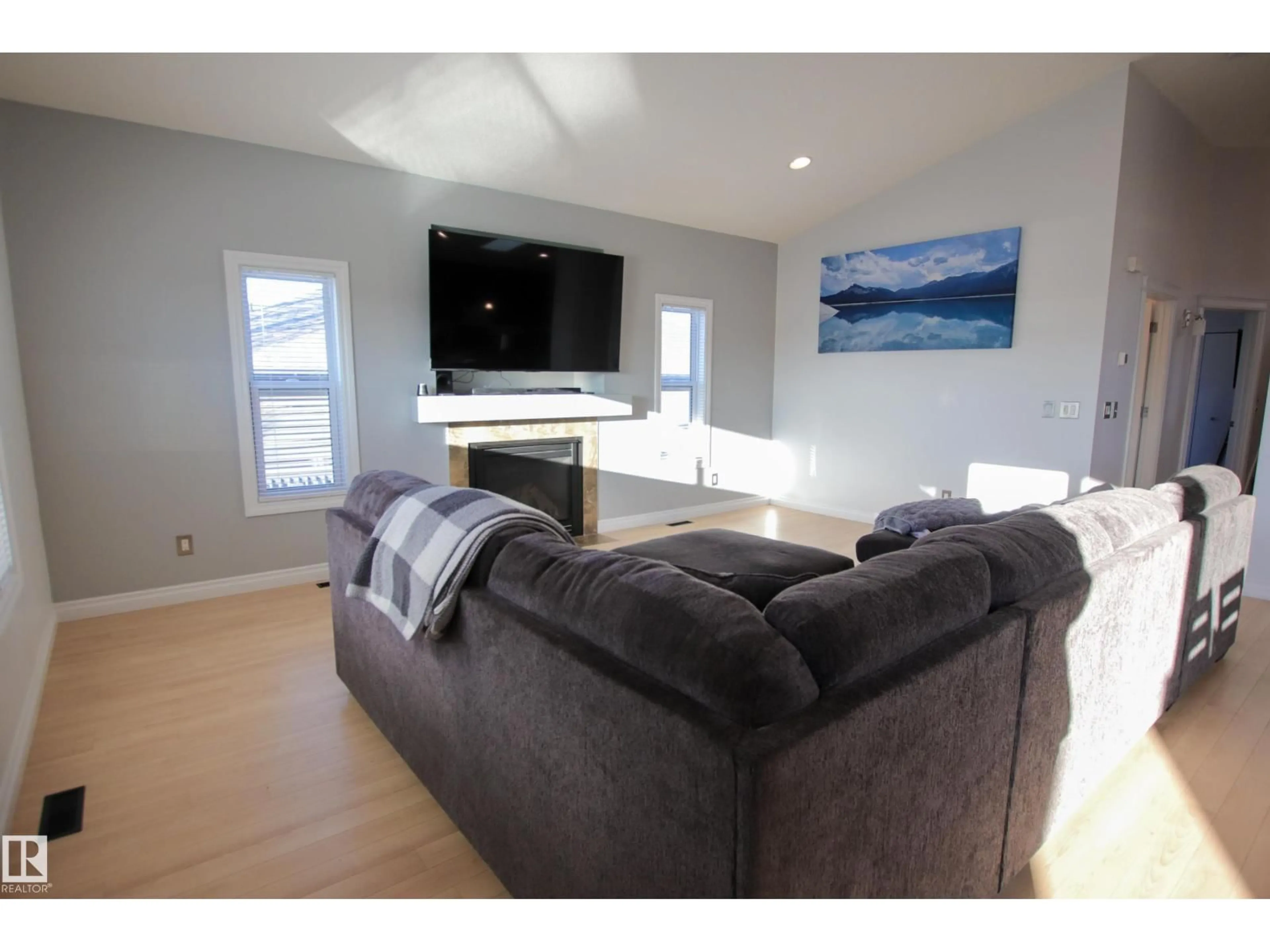 Living room with furniture, wood/laminate floor for 112 HOULE DR, Morinville Alberta T8R0E1