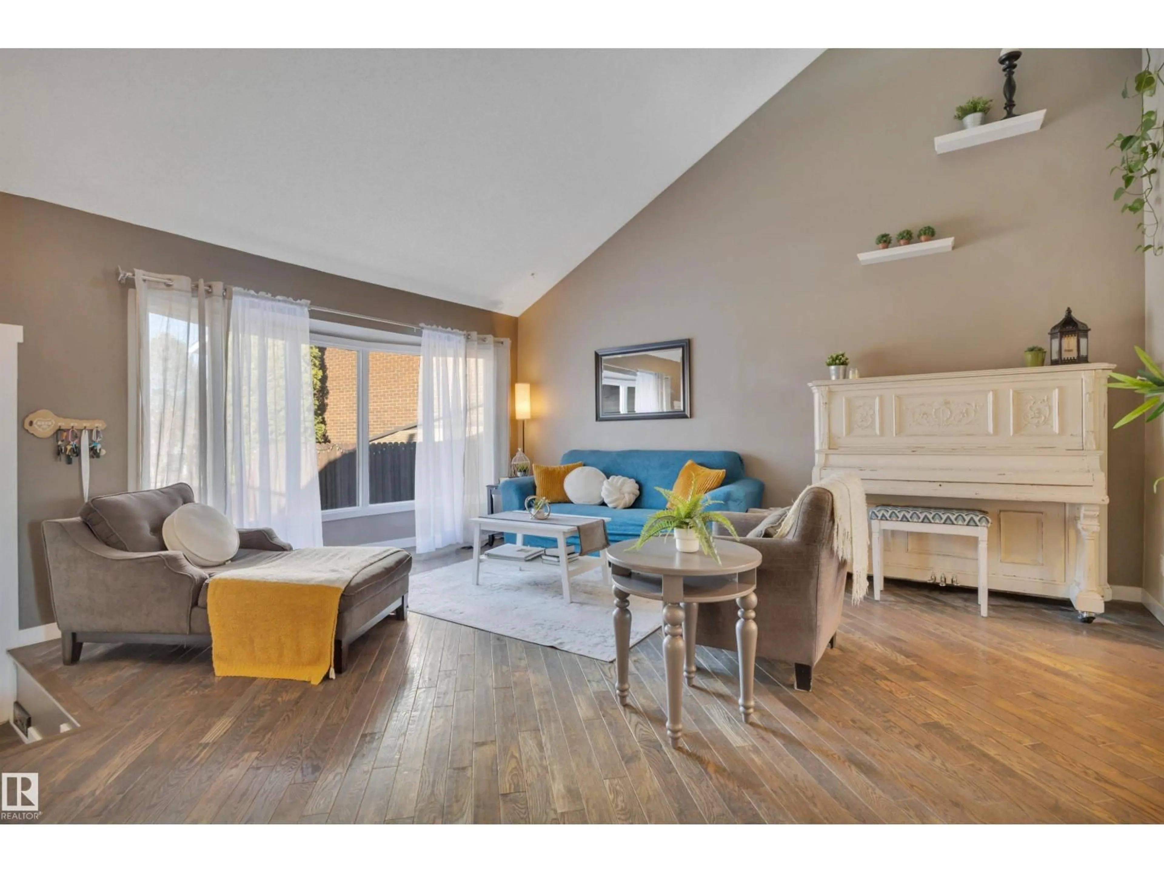 Living room with furniture, wood/laminate floor for 8807 31 AV, Edmonton Alberta T6K3A7