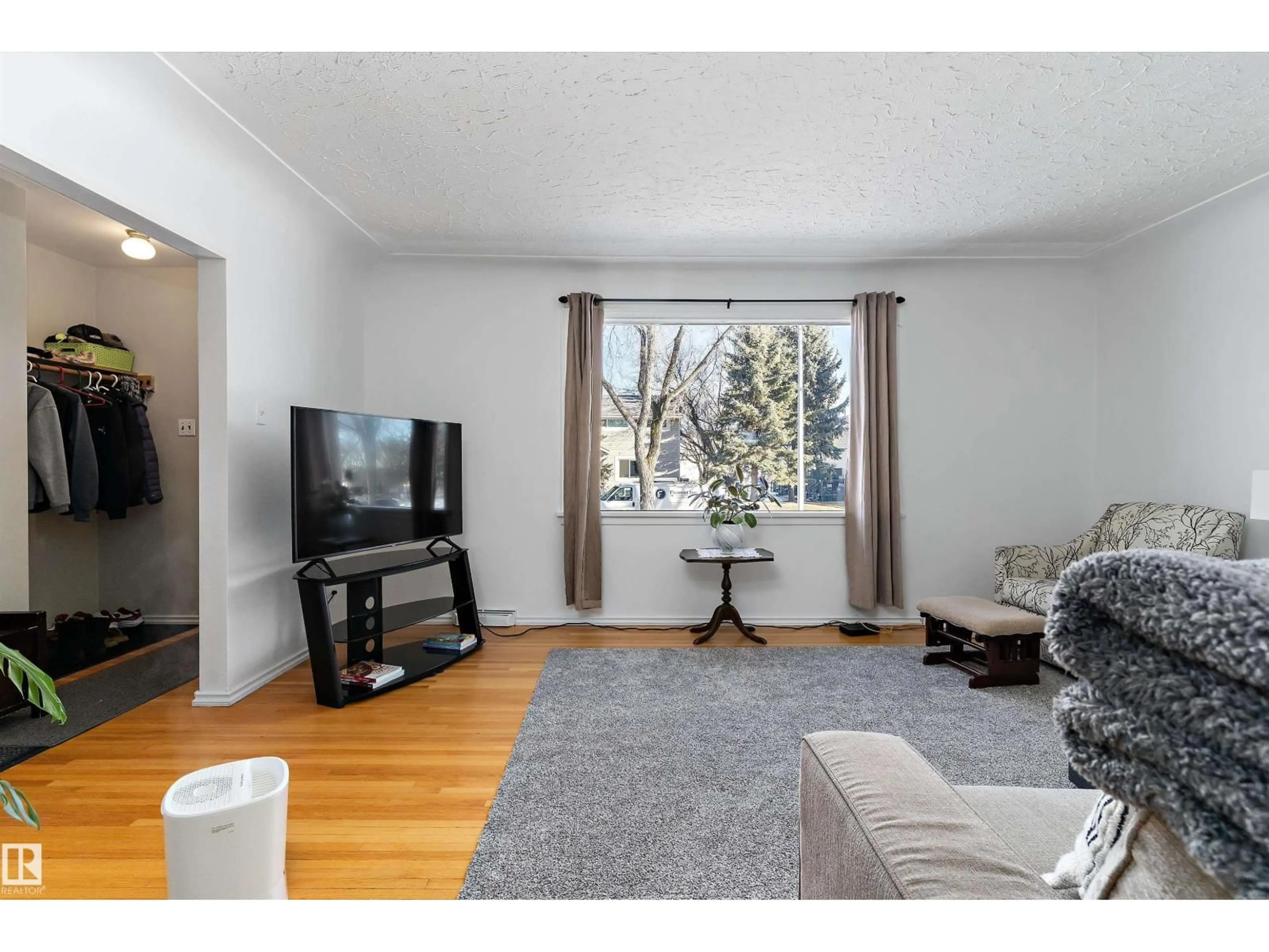 Living room with furniture, wood/laminate floor for 9431 65 AV, Edmonton Alberta T6E0K1