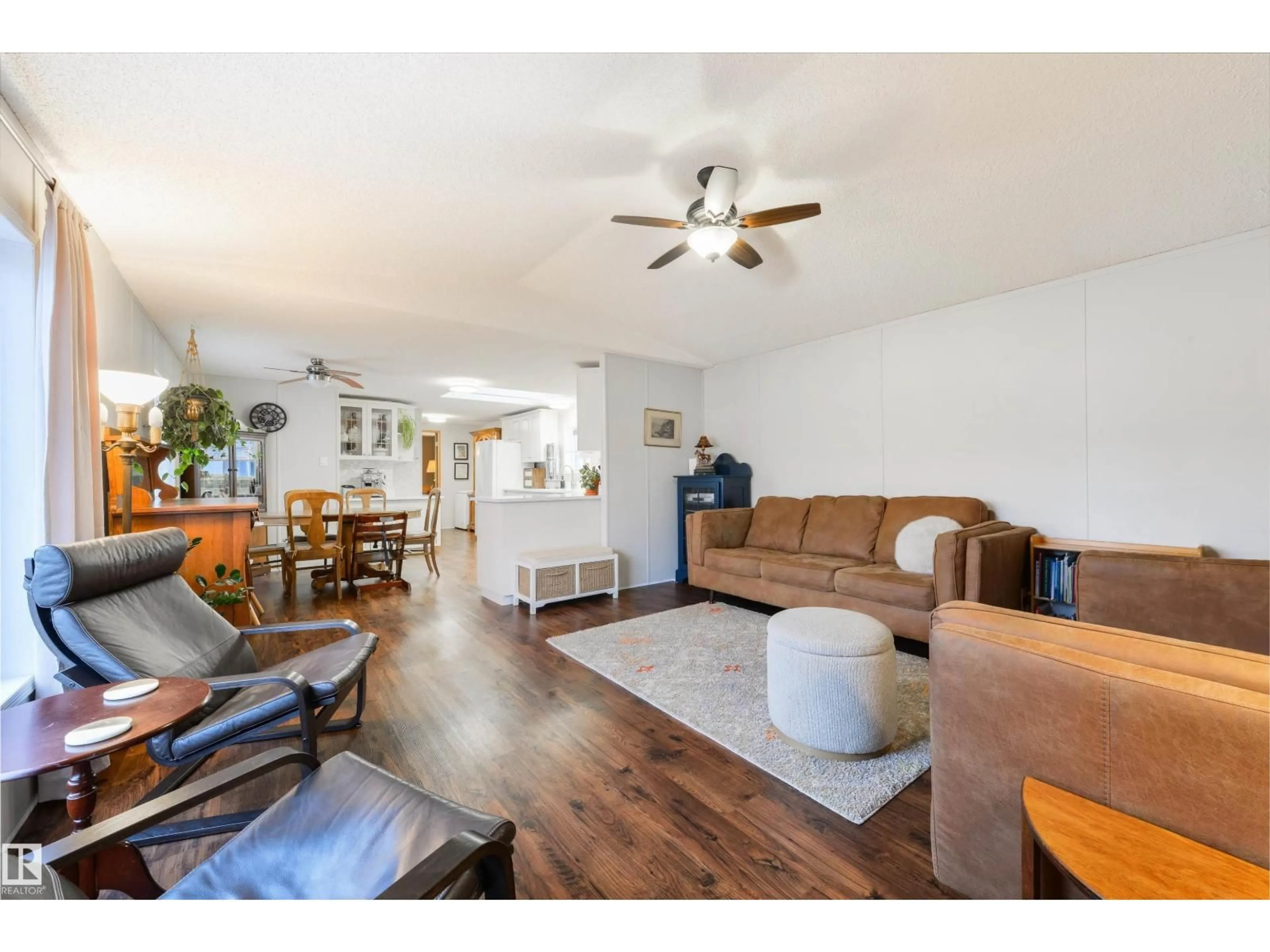 Living room with furniture, wood/laminate floor for 172 3400 48 ST, Stony Plain Alberta T7Z1S1