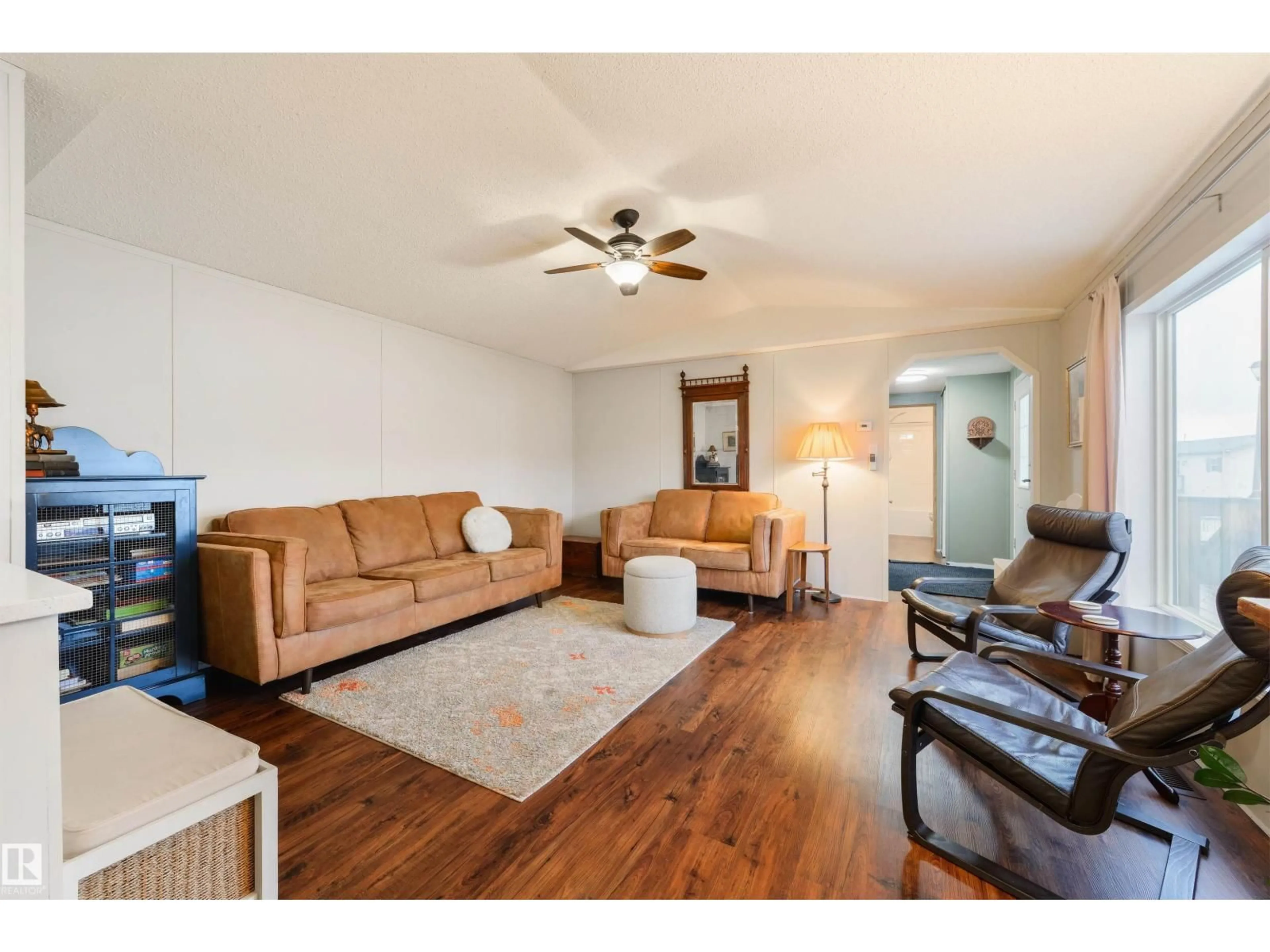 Living room with furniture, wood/laminate floor for 172 3400 48 ST, Stony Plain Alberta T7Z1S1