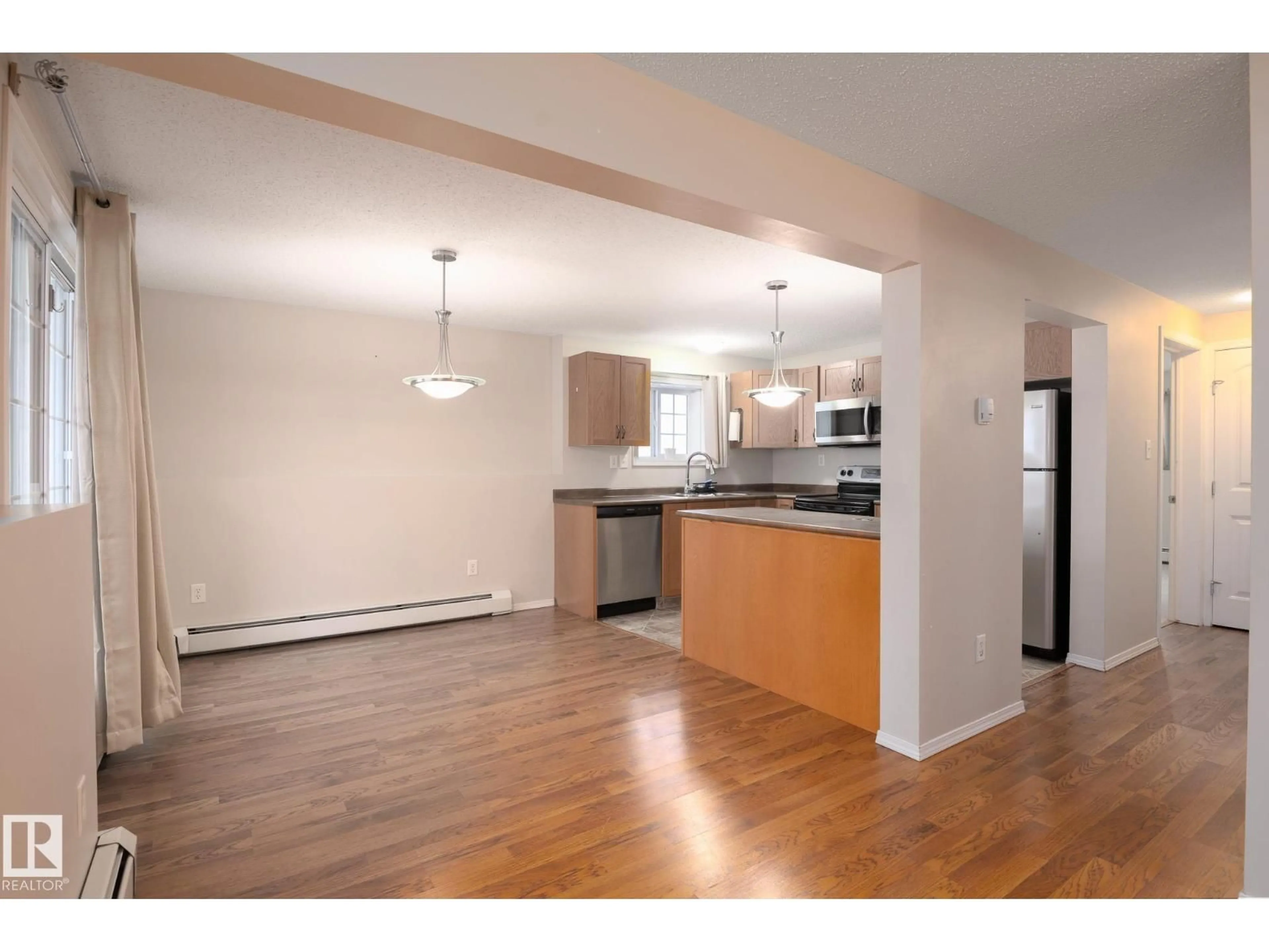 Open concept kitchen, wood/laminate floor for 902 - 1 13 ST, Cold Lake Alberta T9M0C7
