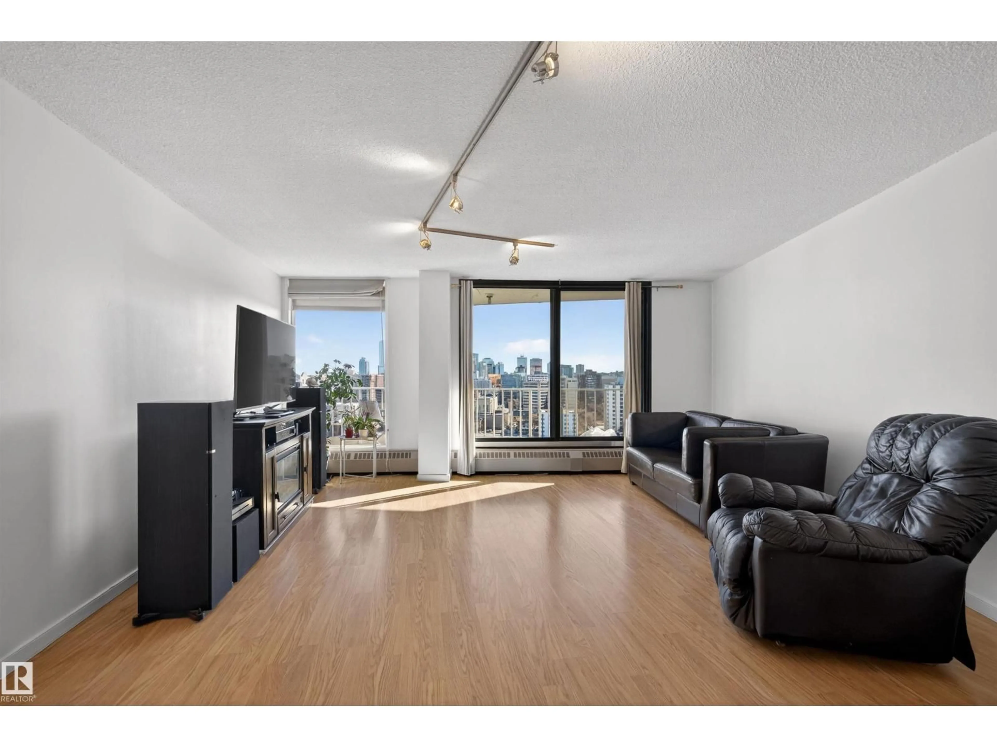 Living room with furniture, wood/laminate floor for 10045 - 1608 117 ST, Edmonton Alberta T6C2C1
