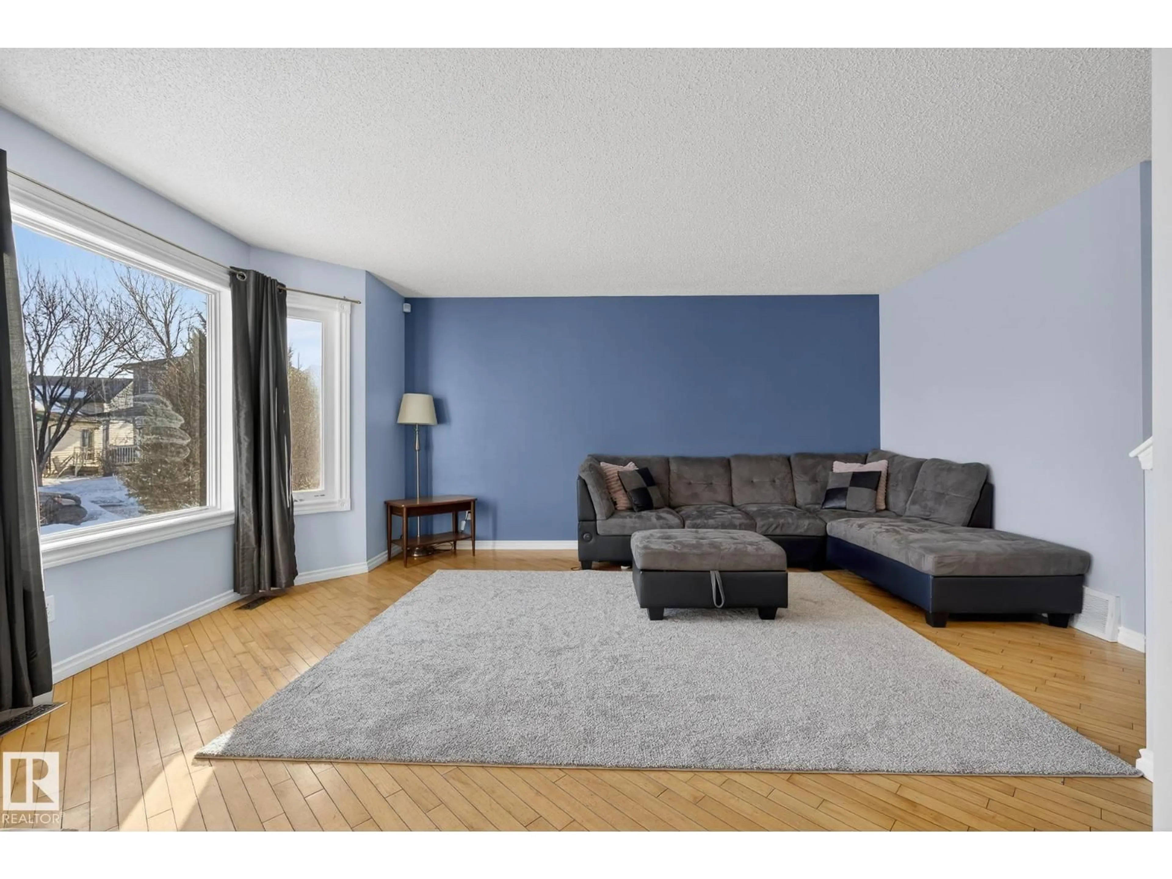 Living room with furniture, wood/laminate floor for 14816 47 ST, Edmonton Alberta T5Y2X3