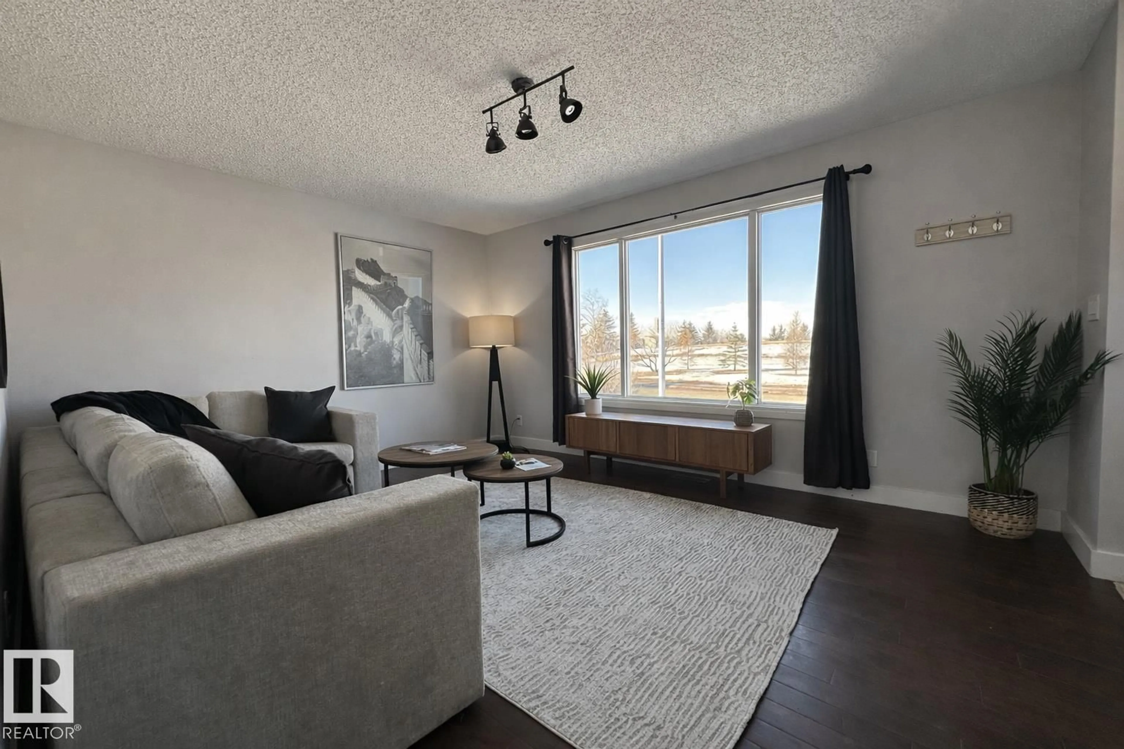 Living room with furniture, wood/laminate floor for 2111 146 AV, Edmonton Alberta T5Y1T6