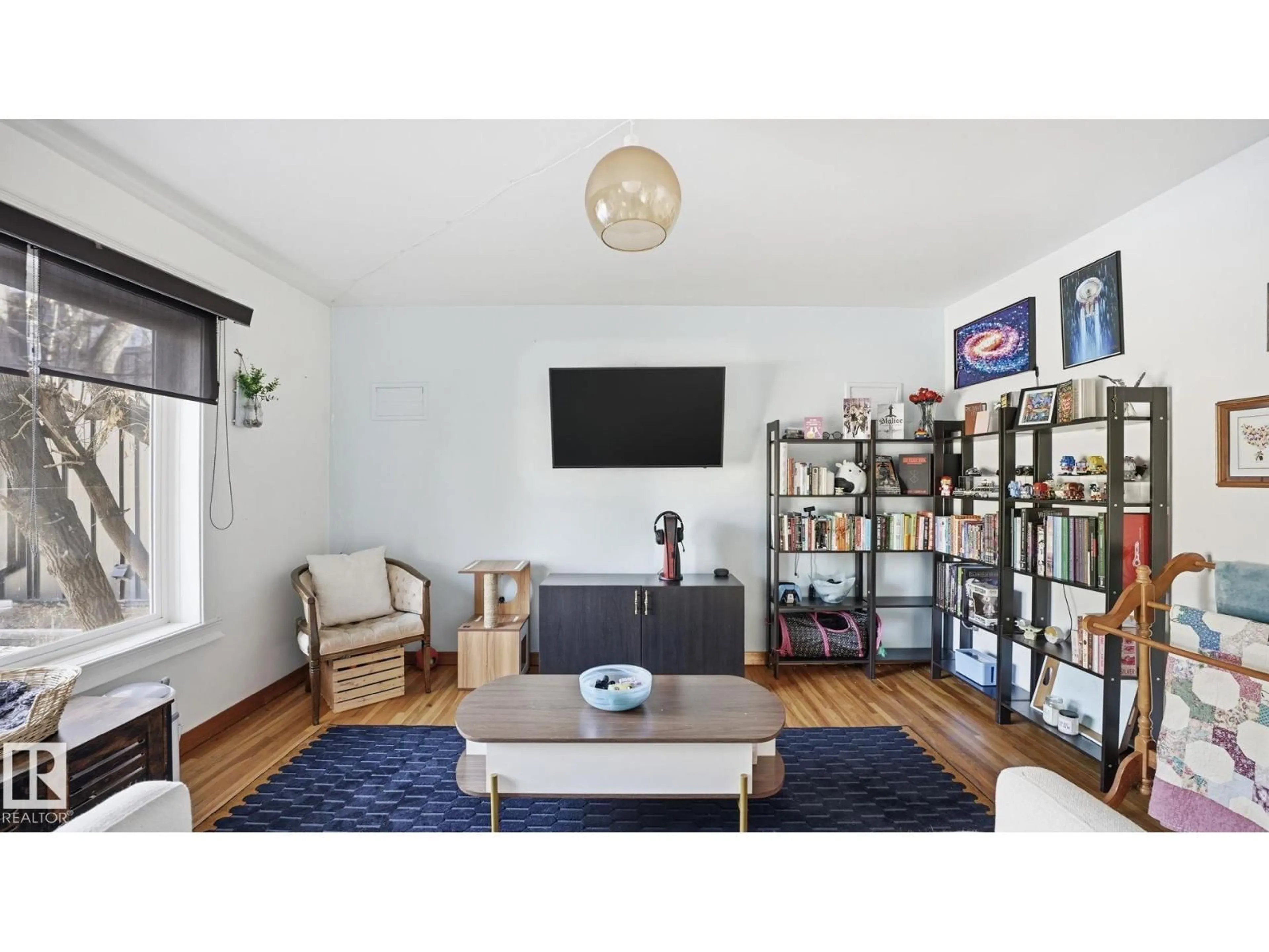 Living room with furniture, wood/laminate floor for NW - 10922 117 ST, Edmonton Alberta T5N3N6