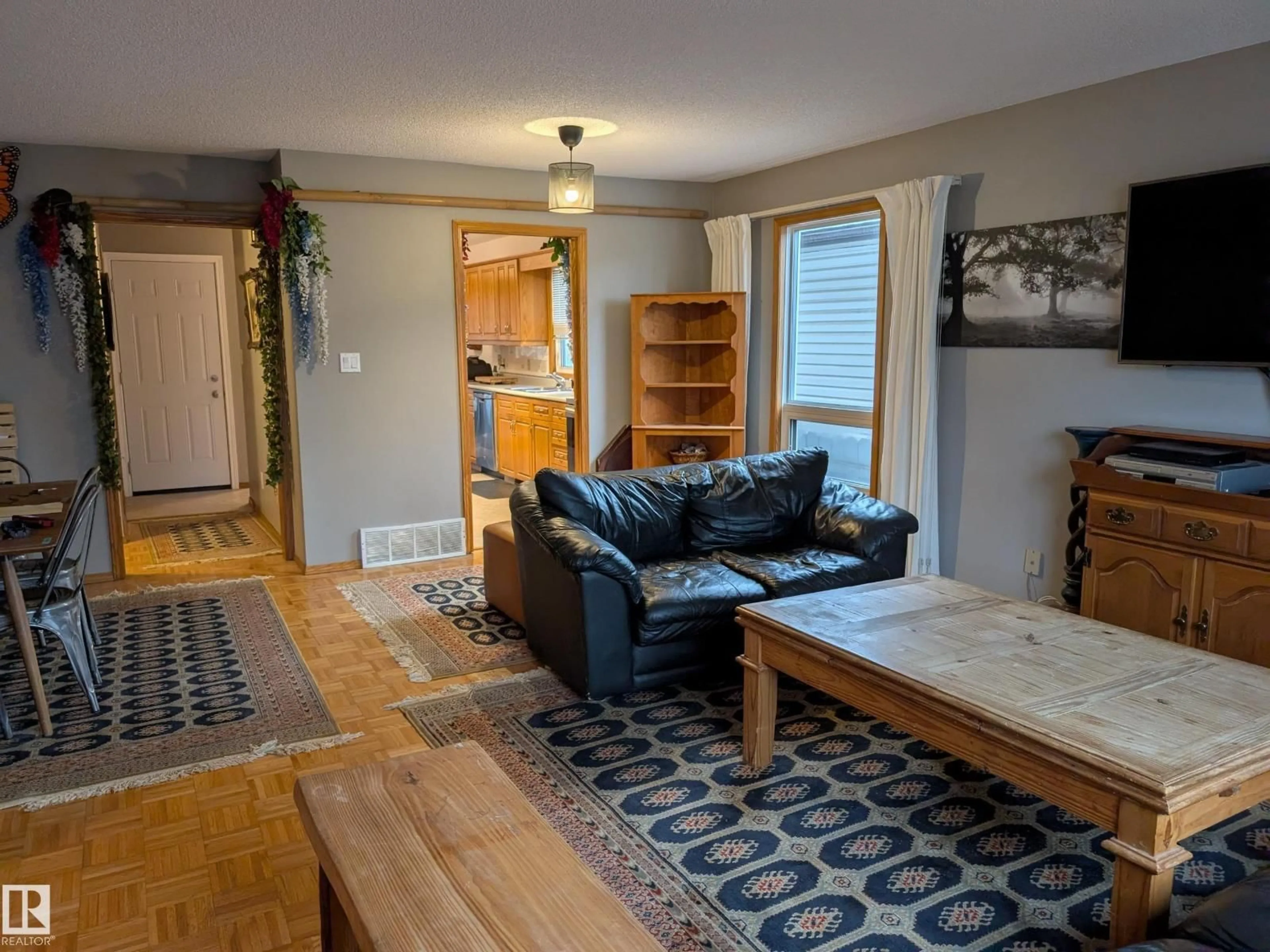 Living room with furniture, wood/laminate floor for 10645 65 AV, Edmonton Alberta T6H1V5