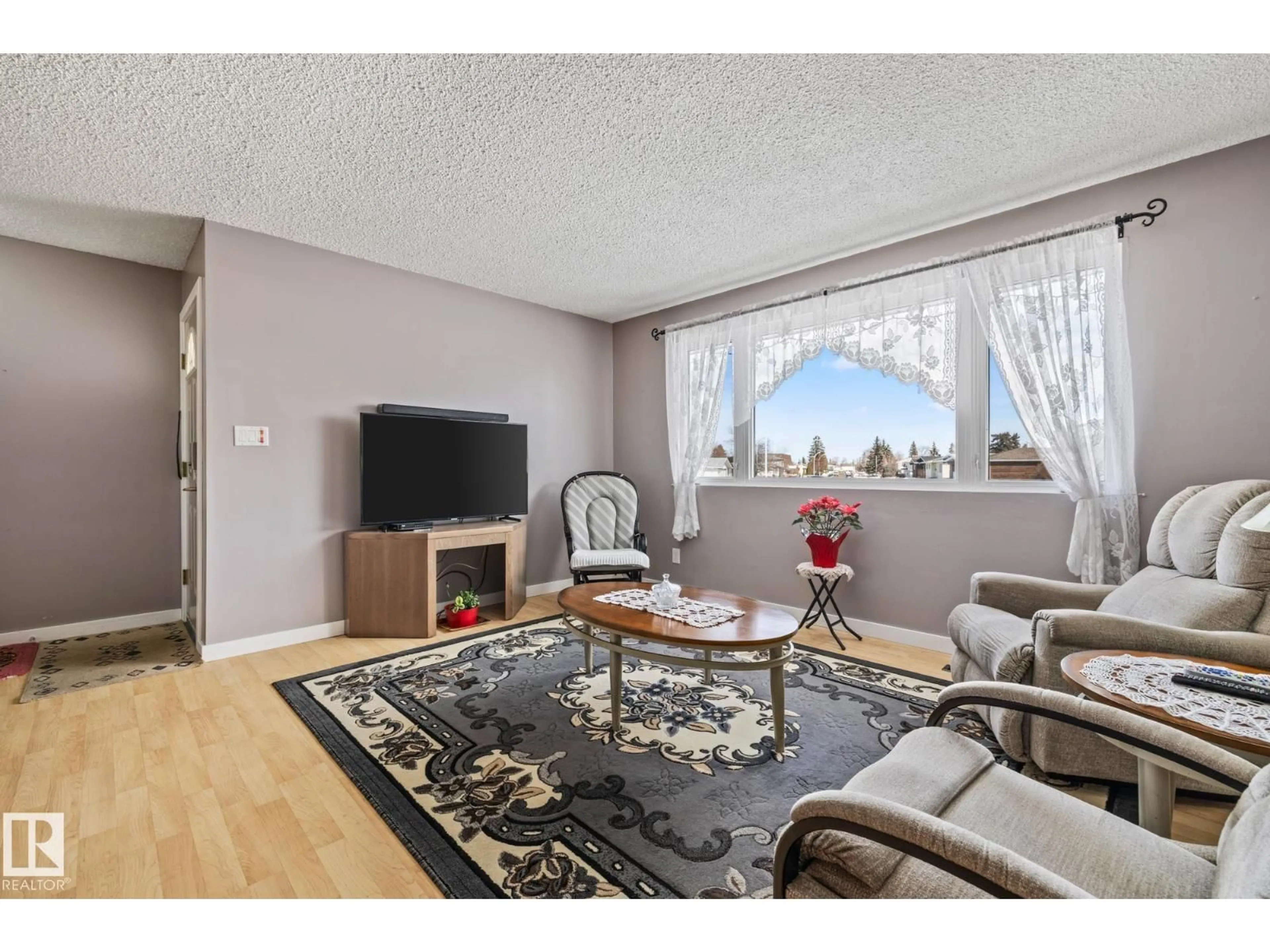 Living room with furniture, wood/laminate floor for NW - 11431 149 AV, Edmonton Alberta T5X1B9