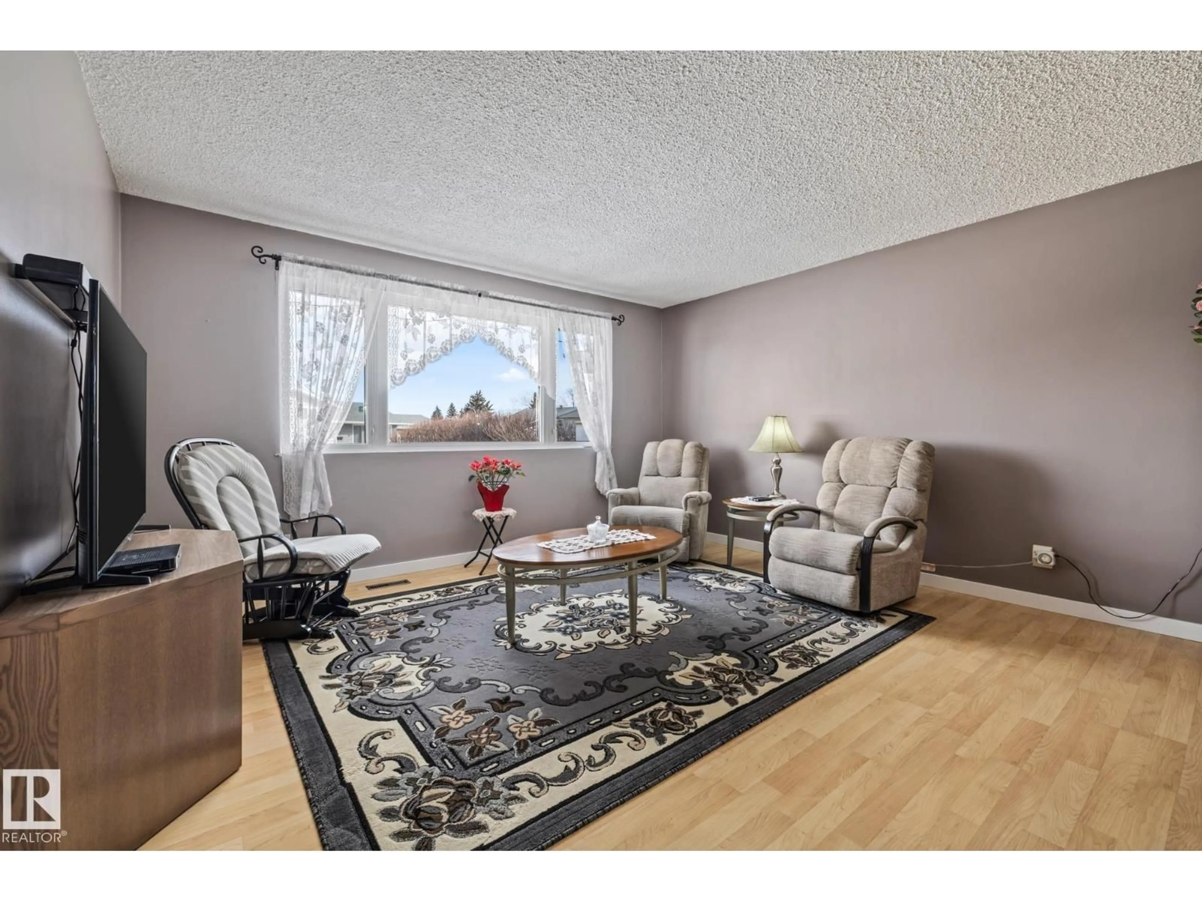 Living room with furniture, wood/laminate floor for NW - 11431 149 AV, Edmonton Alberta T5X1B9