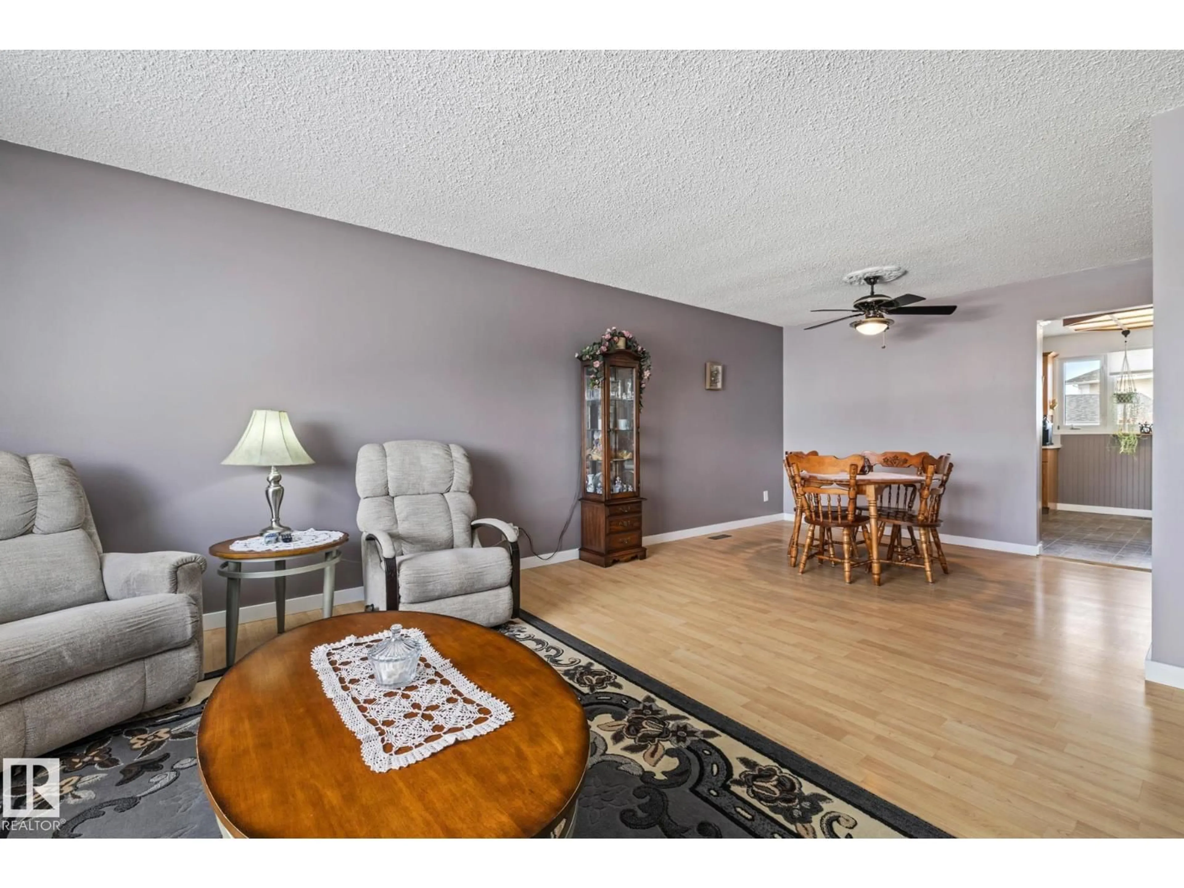 Living room with furniture, wood/laminate floor for NW - 11431 149 AV, Edmonton Alberta T5X1B9