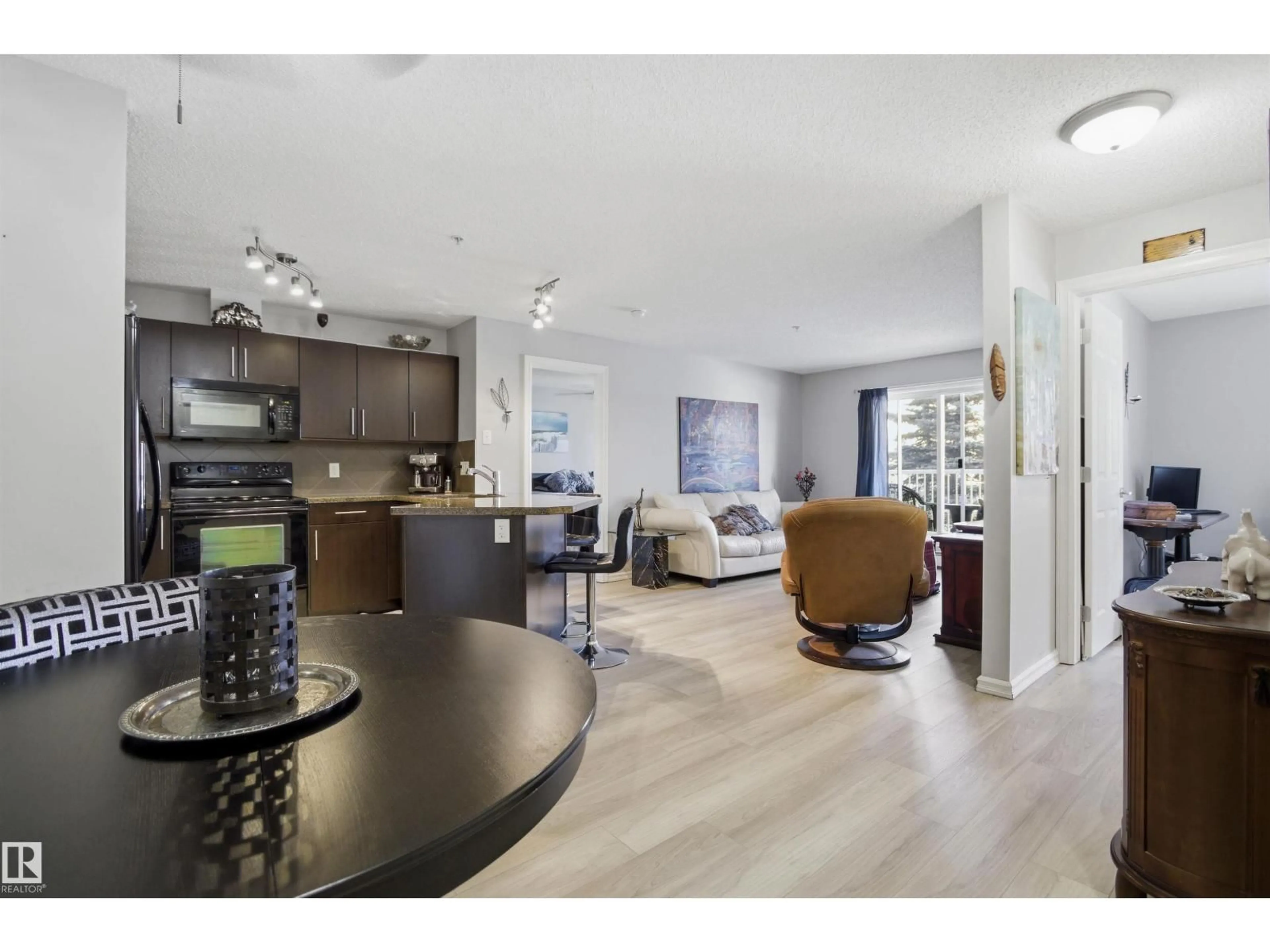 Open concept kitchen, wood/laminate floor for #115 - 2208 44 AV, Edmonton Alberta T6T0G6