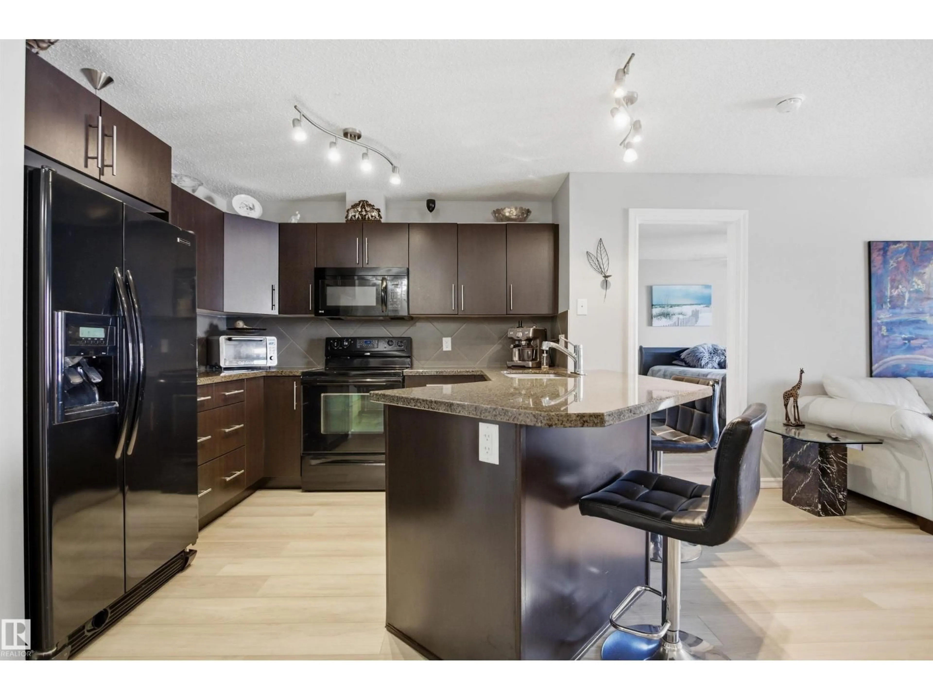 Open concept kitchen, wood/laminate floor for #115 - 2208 44 AV, Edmonton Alberta T6T0G6