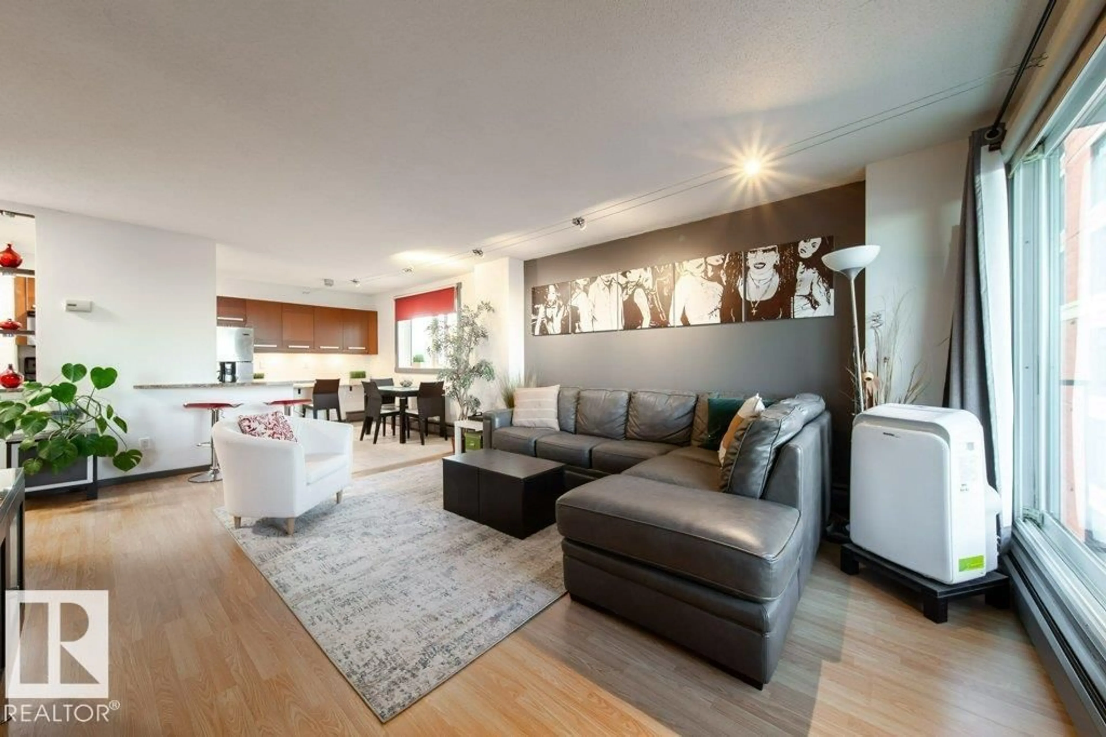 Living room with furniture, wood/laminate floor for 1007 - 9028 JASPER AV, Edmonton Alberta T5H3Y6