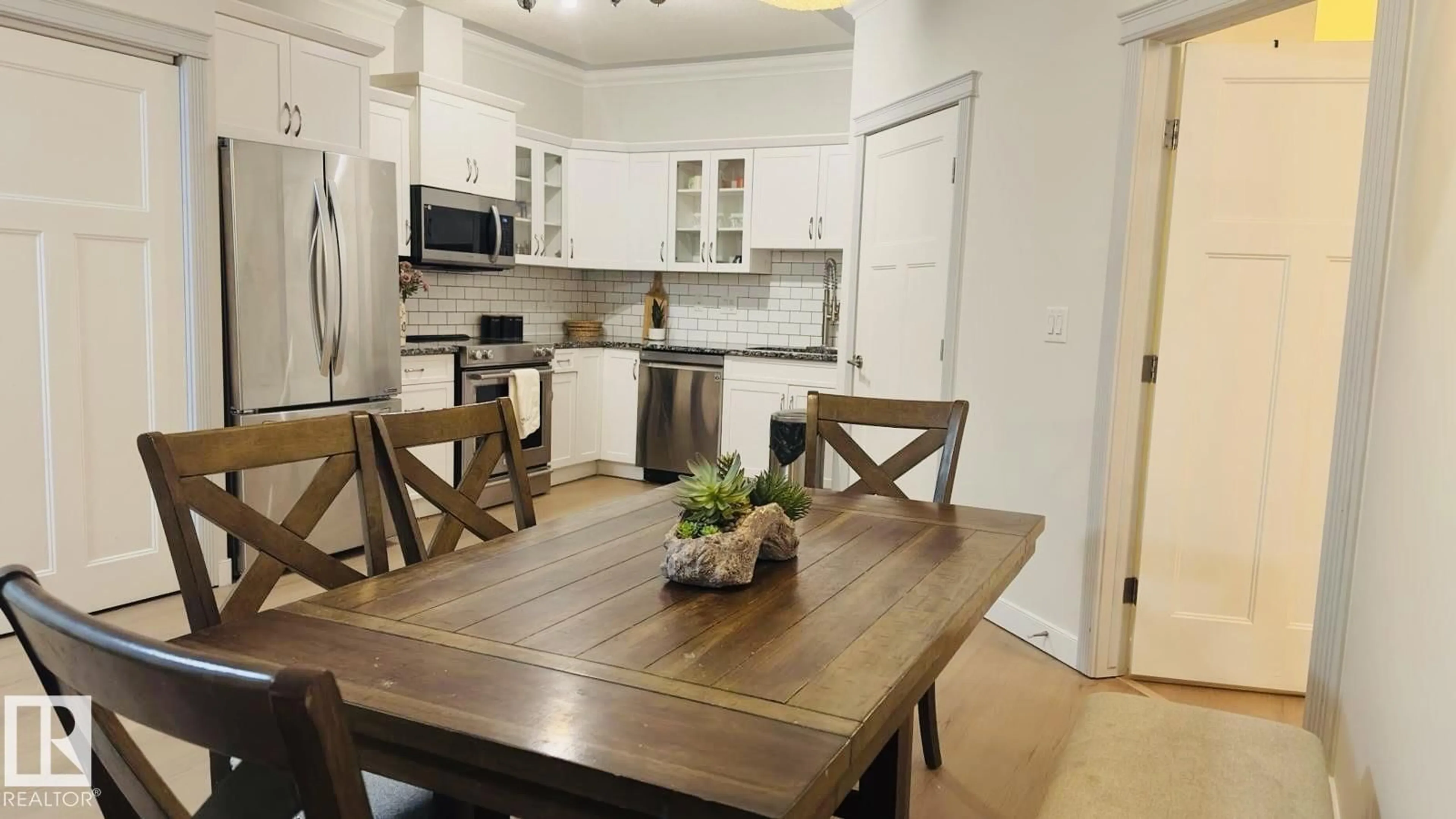 Open concept kitchen, wood/laminate floor for #113 - 16235 51 ST, Edmonton Alberta T5Y0V3