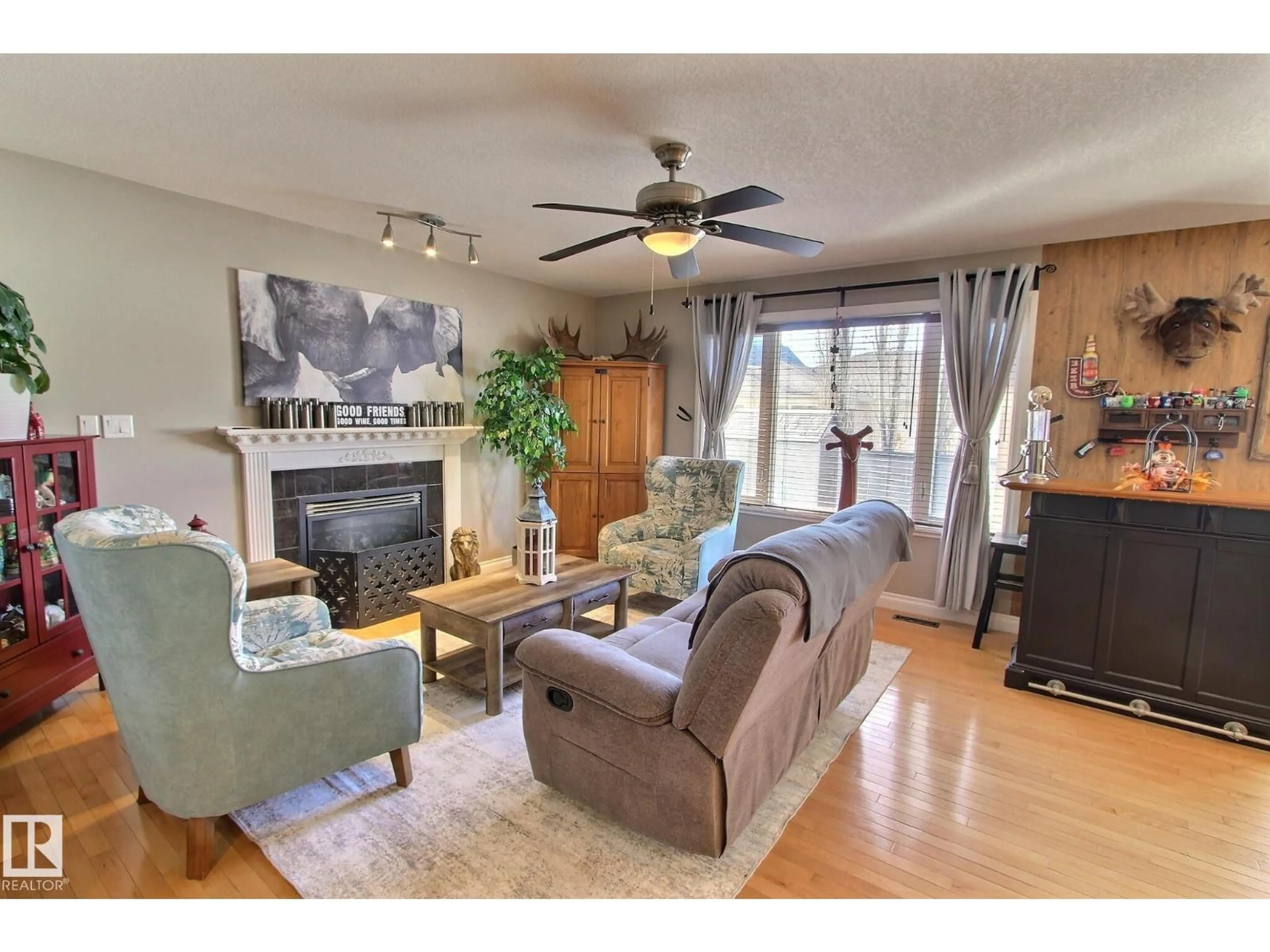 Living room with furniture, wood/laminate floor for 12 BIRCHMONT CR, Leduc Alberta T9E8S3