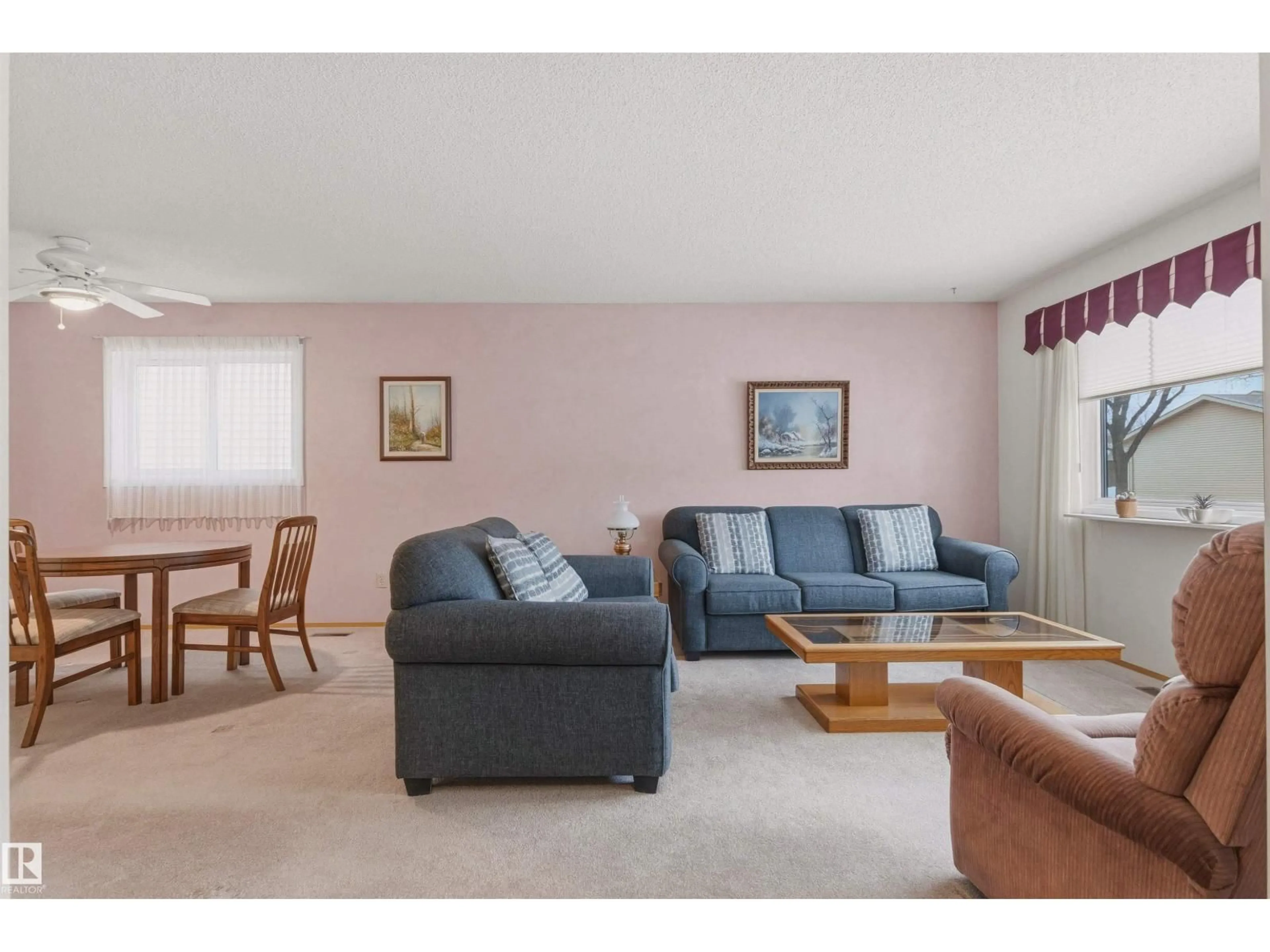 Living room with furniture, wood/laminate floor for 10670 153 AV, Edmonton Alberta T5X5R7
