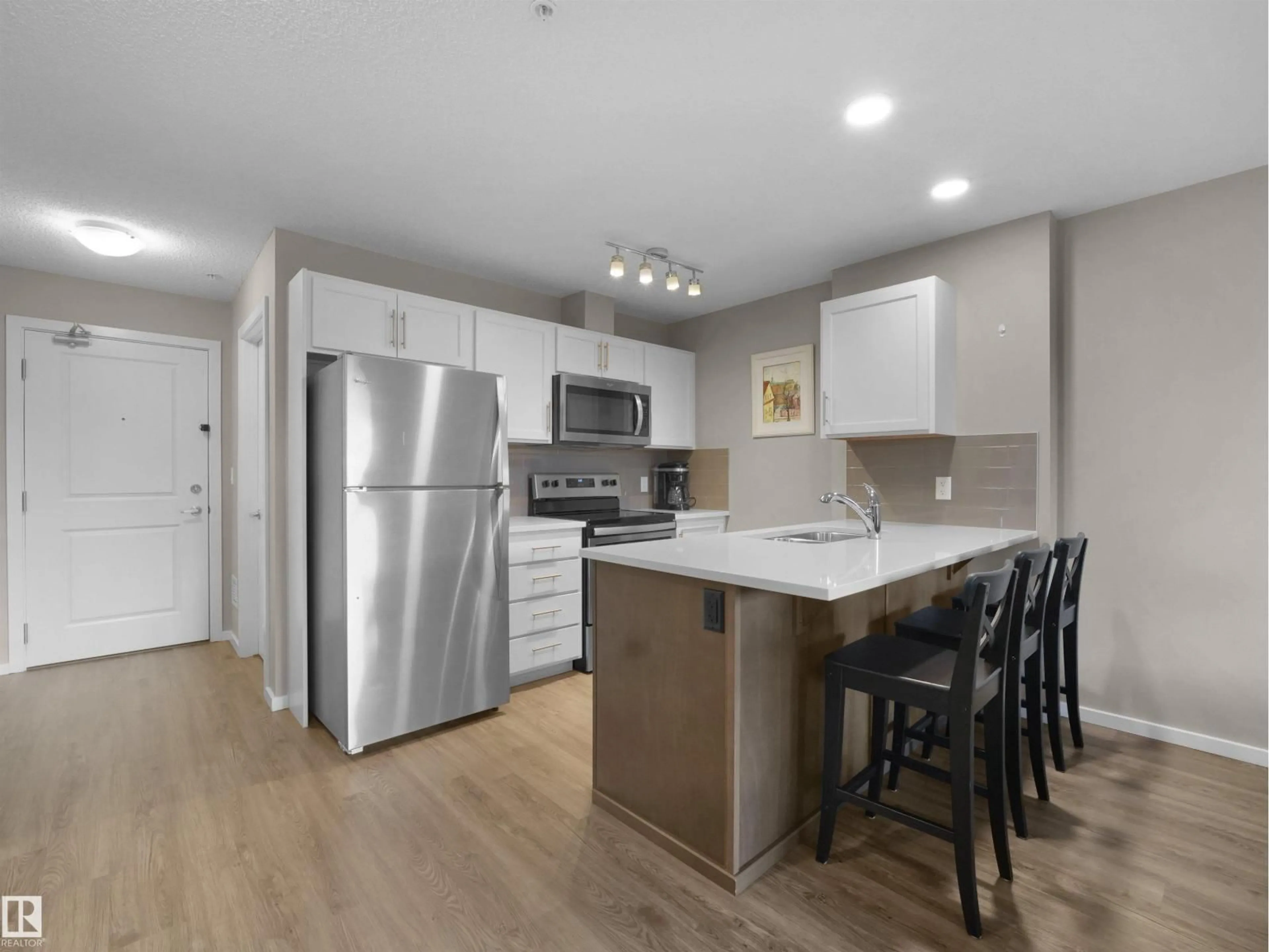 Open concept kitchen, wood/laminate floor for #214 - 394 WINDERMERE RD, Edmonton Alberta T6W0R1
