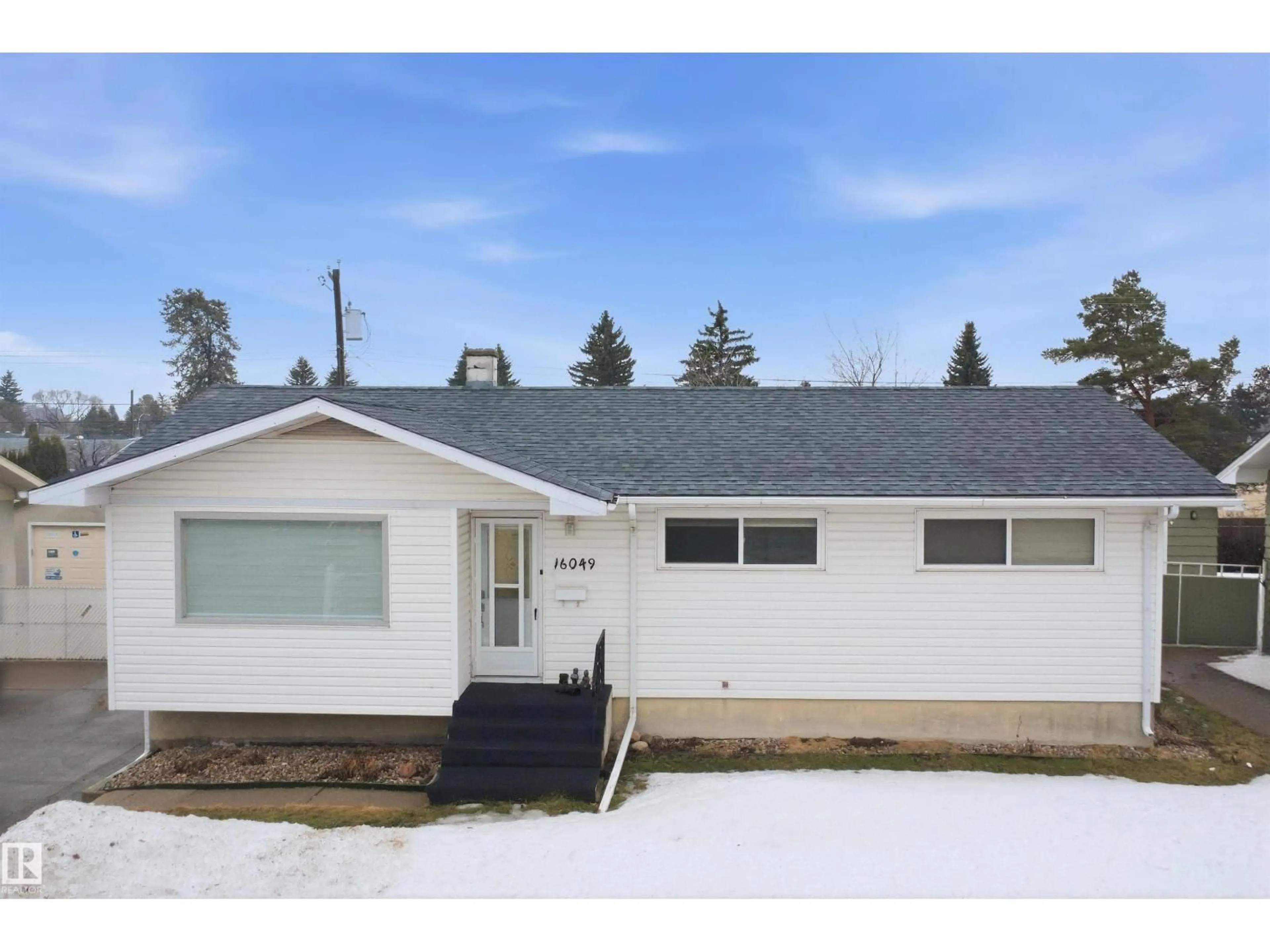 Home with vinyl exterior material, street for 16049 95 AV, Edmonton Alberta T5P0A8