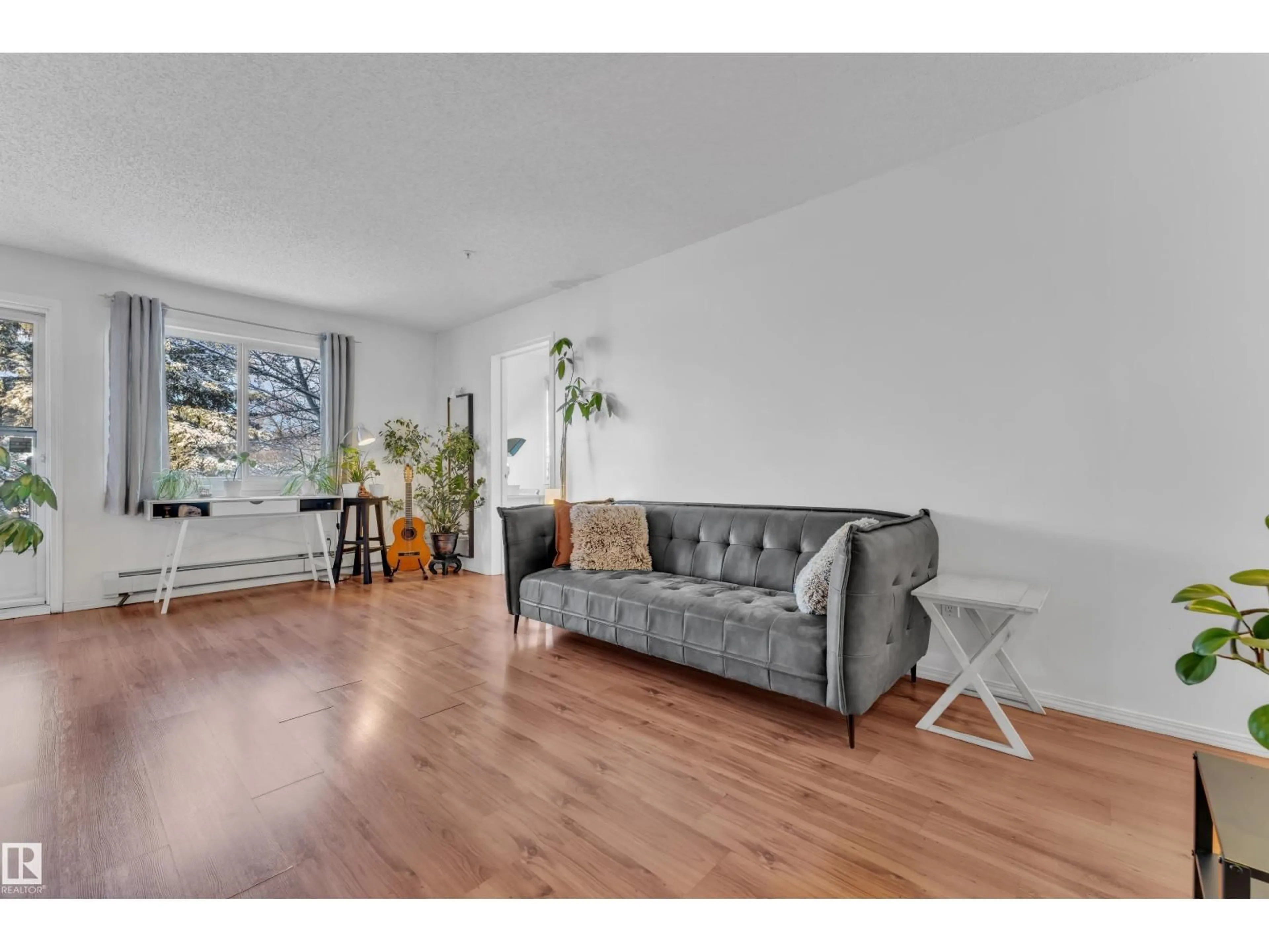 Living room with furniture, wood/laminate floor for 105 - 114 MCKENNEY AVE, St. Albert Alberta T8N2Y2