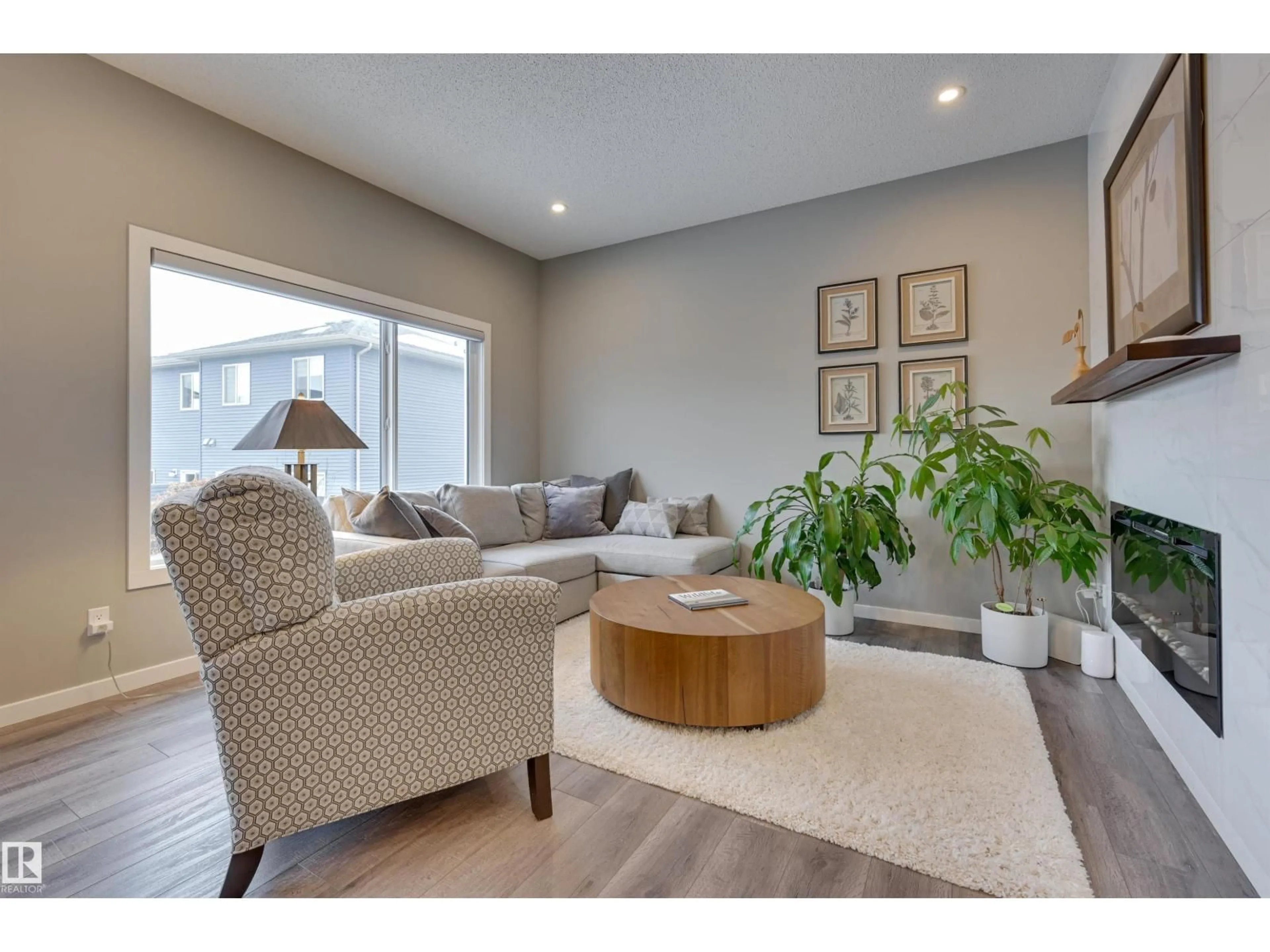 Living room with furniture, wood/laminate floor for 5158 LARK CR, Edmonton Alberta T5S0P2