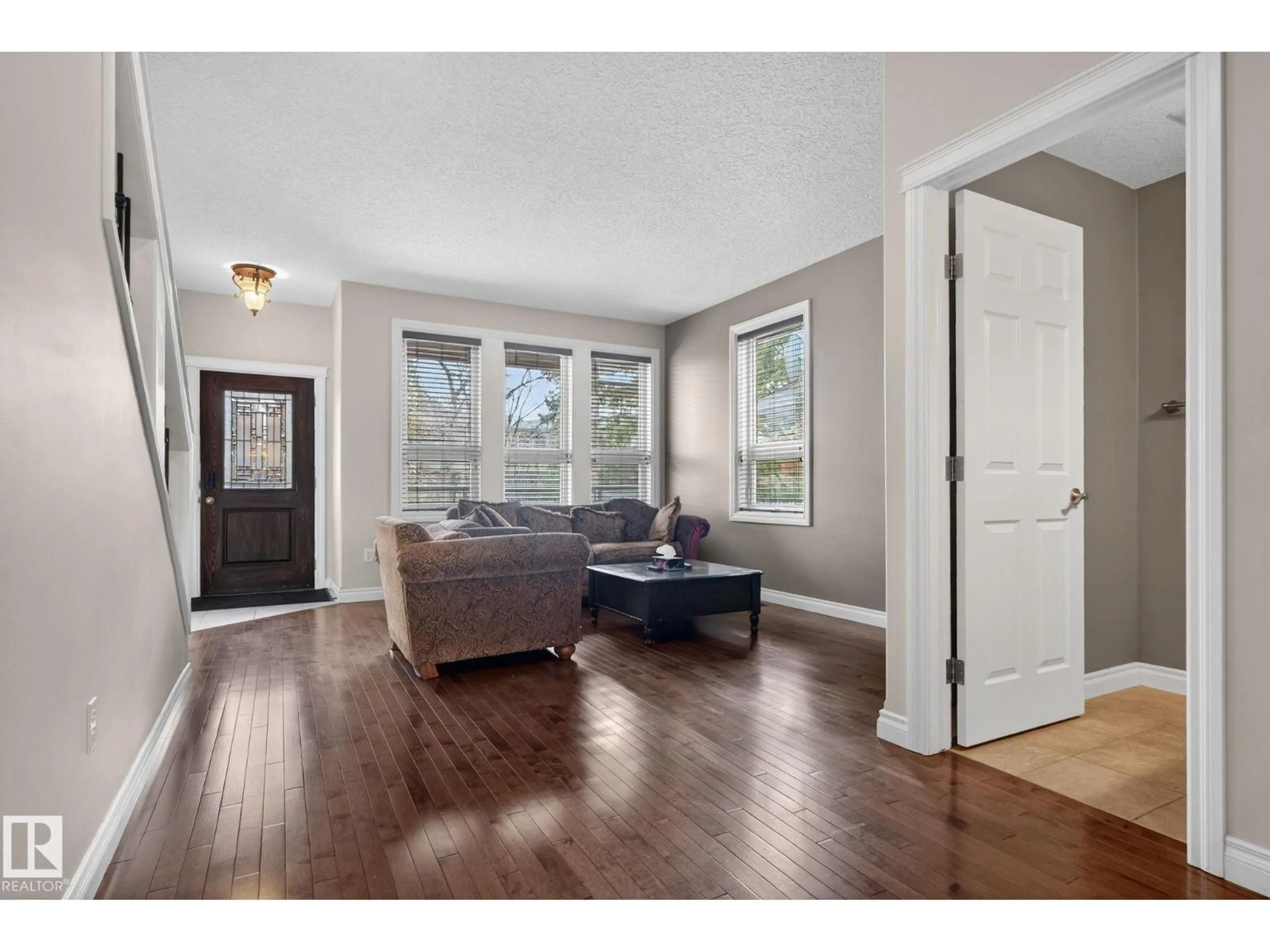 Living room with furniture, wood/laminate floor for NW - 10418 69 AV, Edmonton Alberta T6H2C3