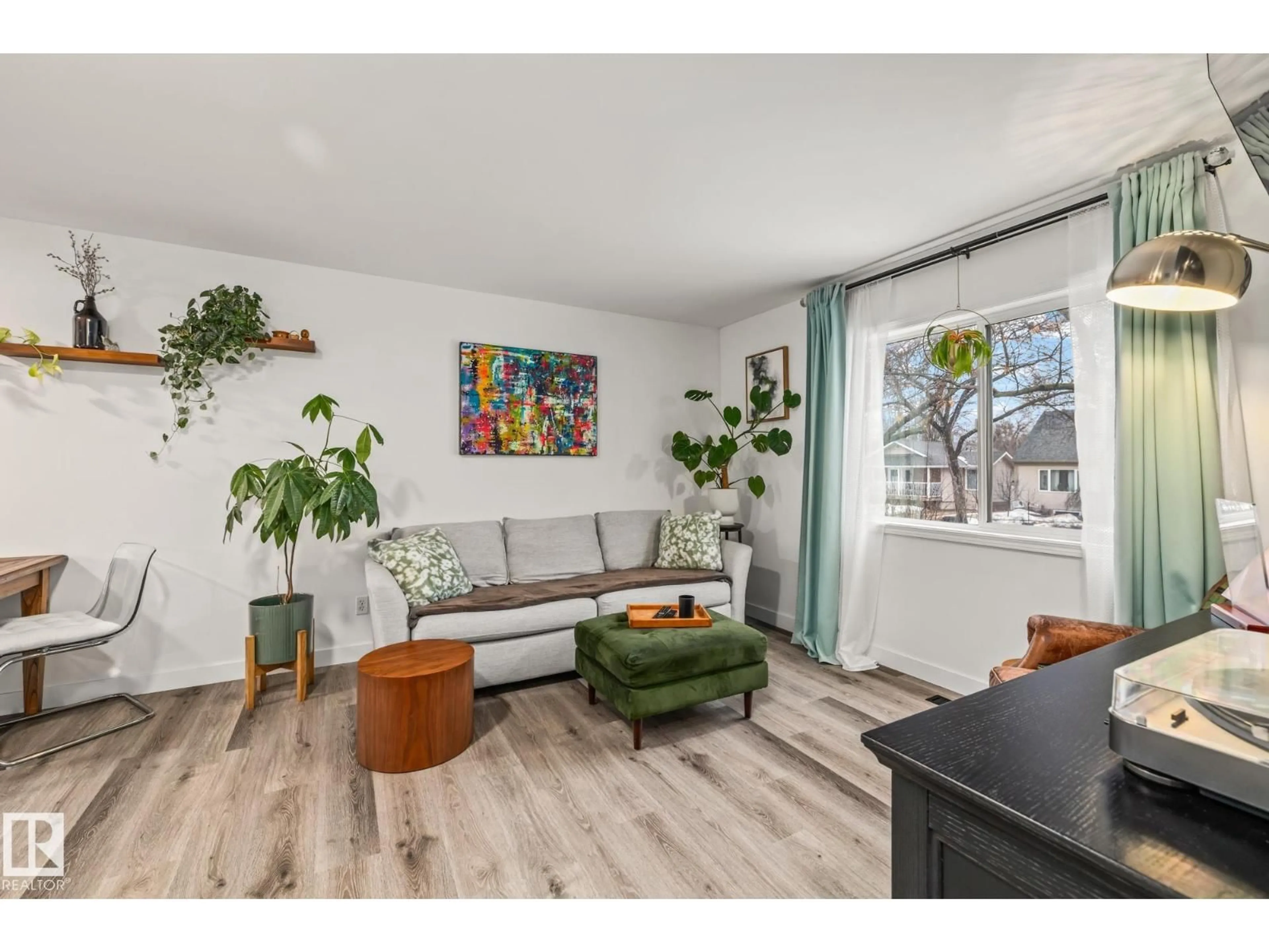 Living room with furniture, wood/laminate floor for 9321 92 ST, Edmonton Alberta T6C3R7