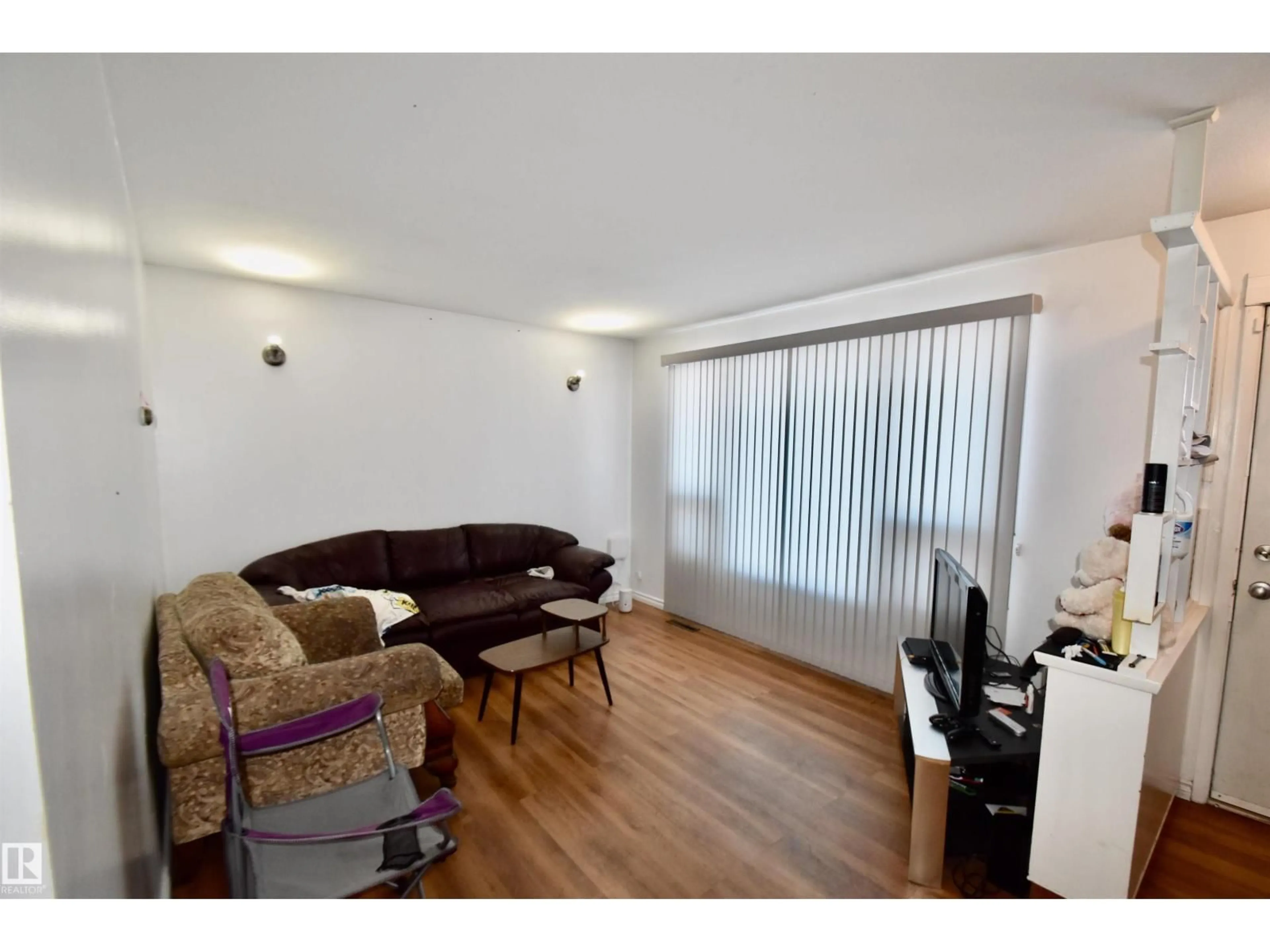 Living room with furniture, wood/laminate floor for 5221 49 AV, St. Paul Town Alberta T0A3A1