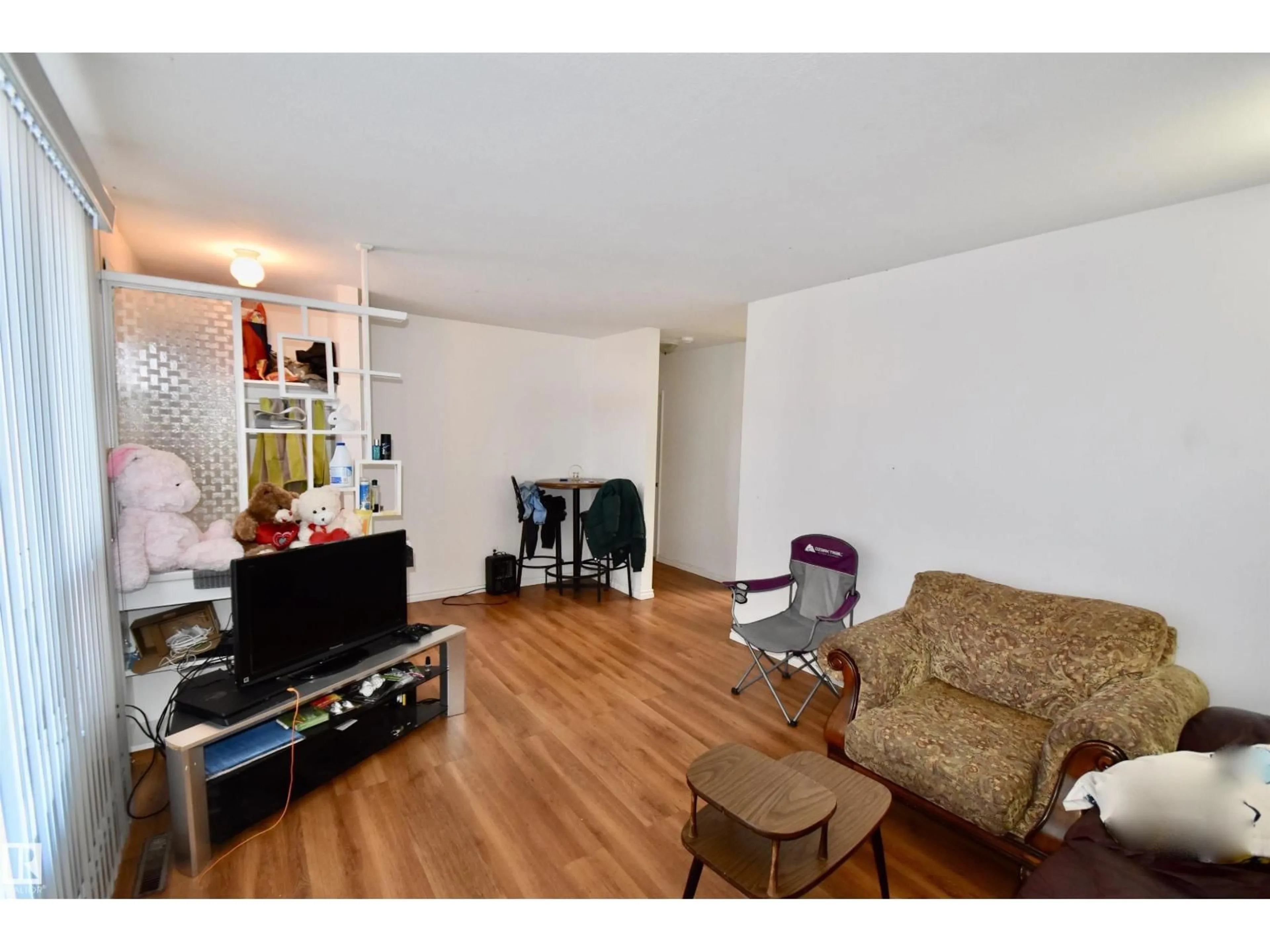 Living room with furniture, wood/laminate floor for 5221 49 AV, St. Paul Town Alberta T0A3A1