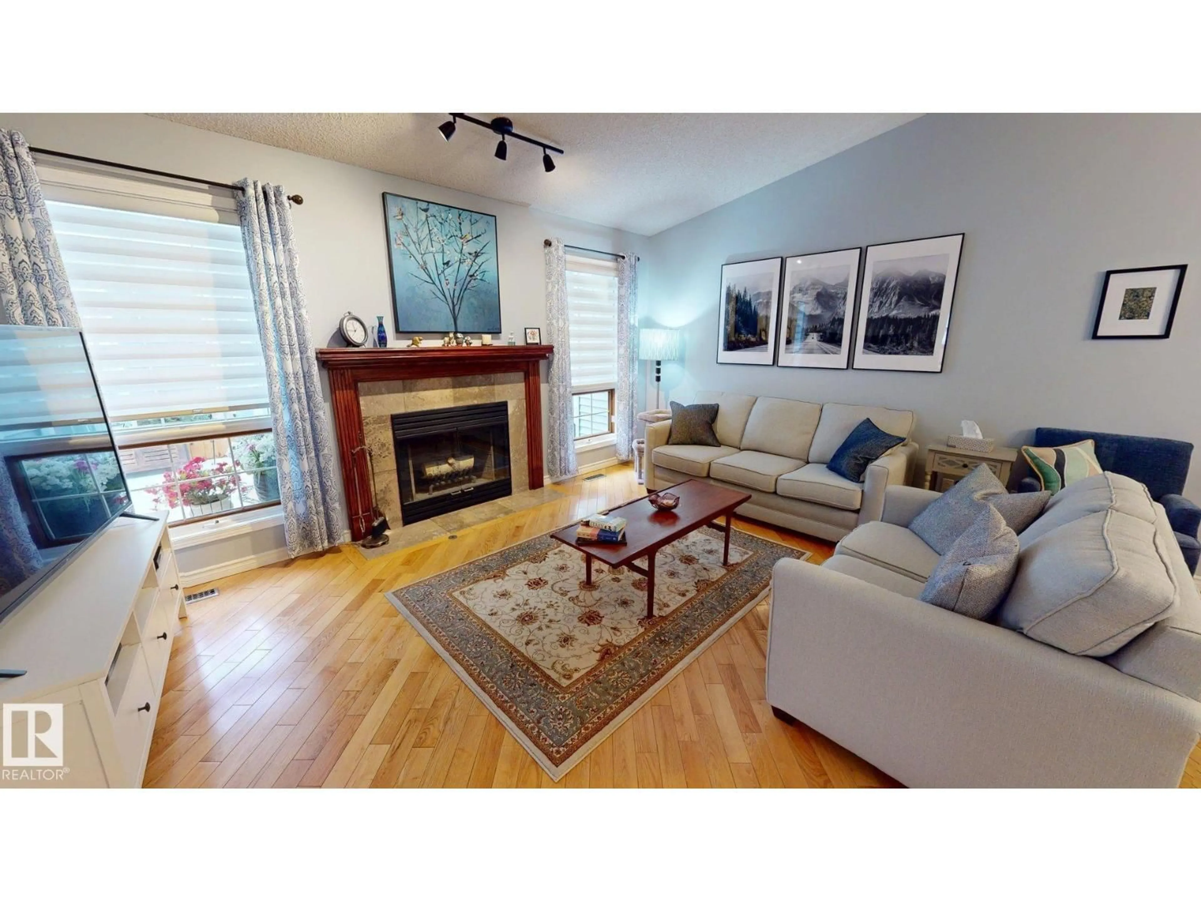 Living room with furniture, wood/laminate floor for 740 WILKIN CL, Edmonton Alberta T6M2H9