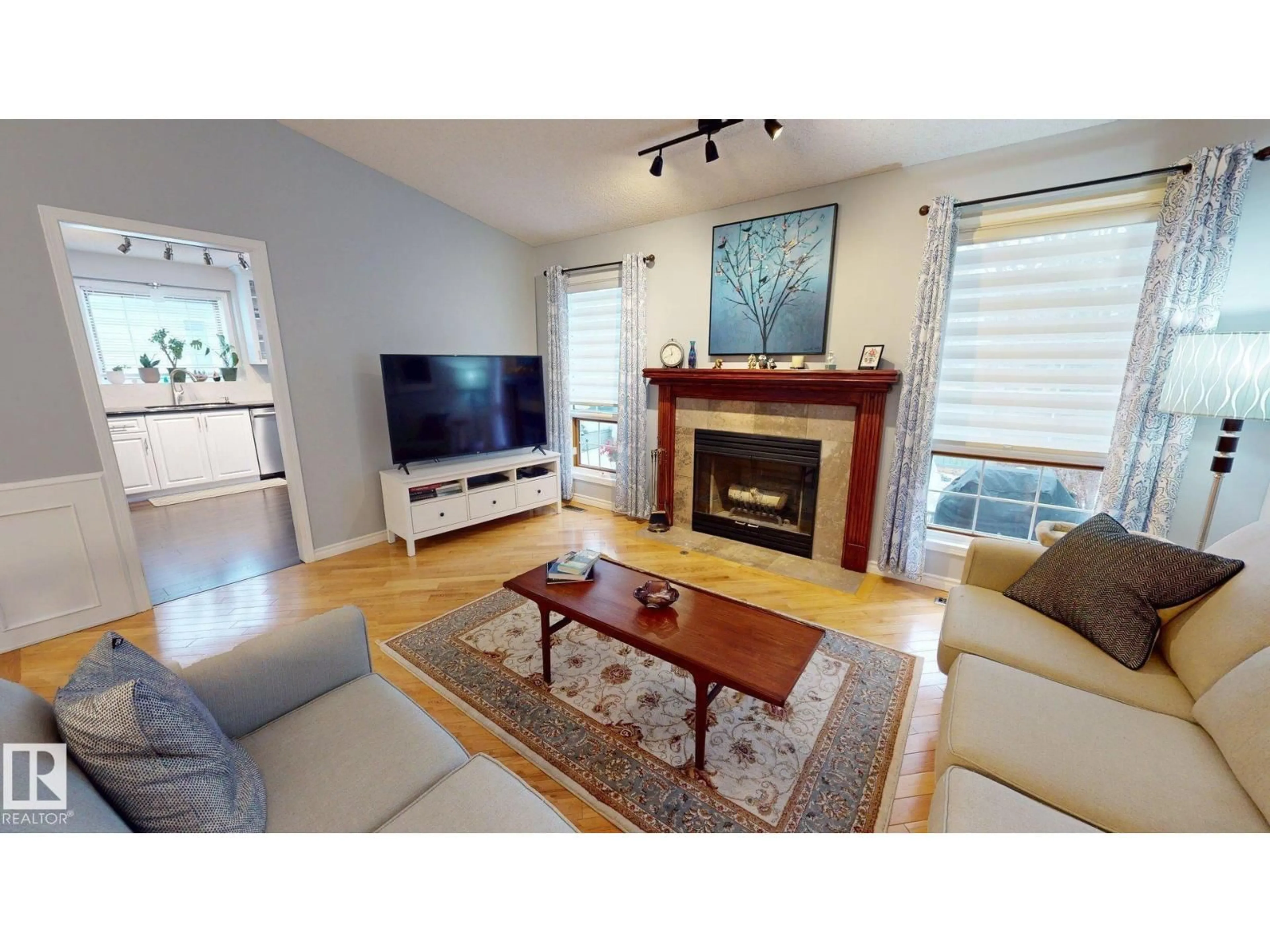 Living room with furniture, wood/laminate floor for 740 WILKIN CL, Edmonton Alberta T6M2H9
