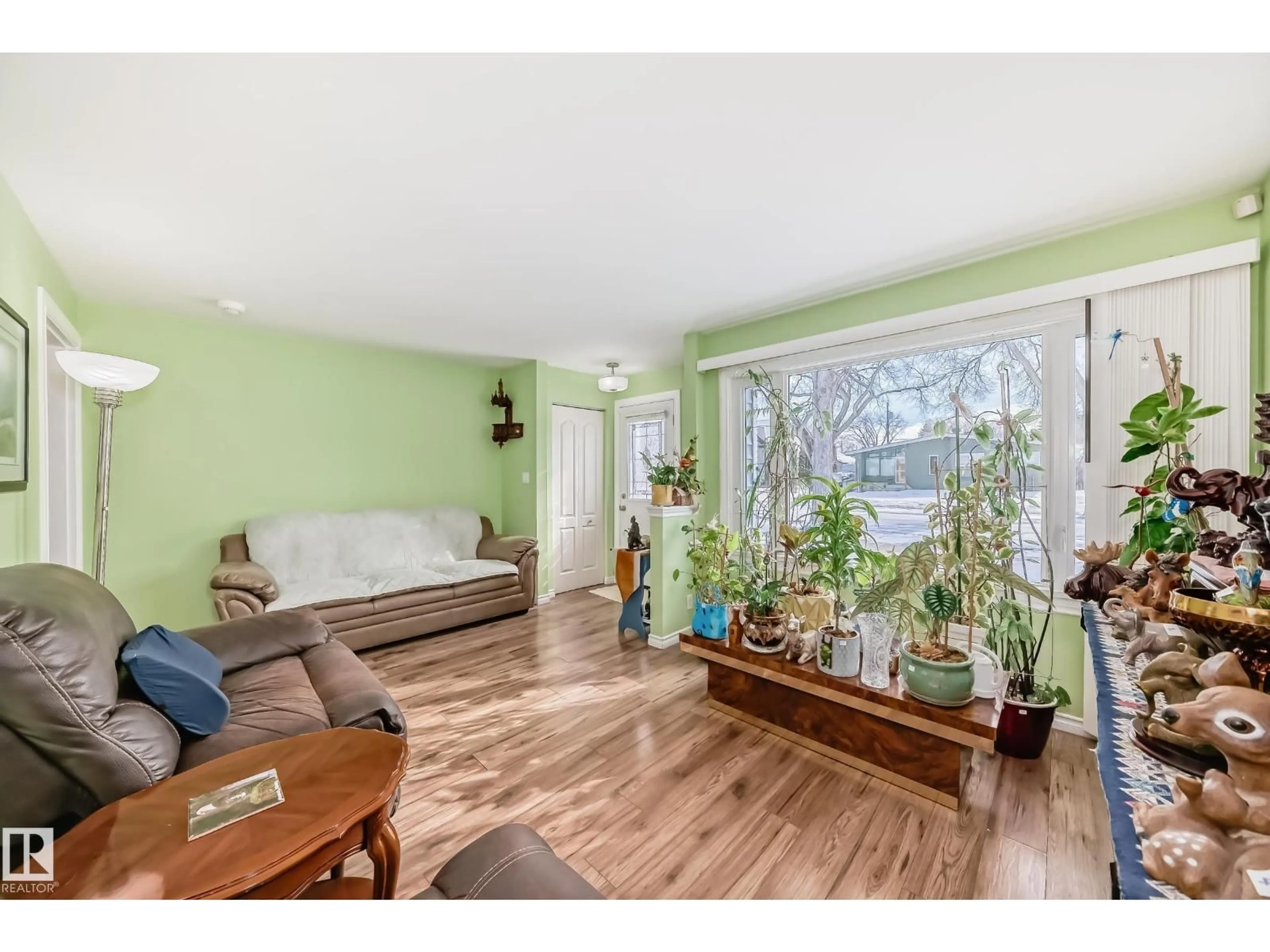 Living room with furniture, wood/laminate floor for 3634 113 AV, Edmonton Alberta T5W0P8