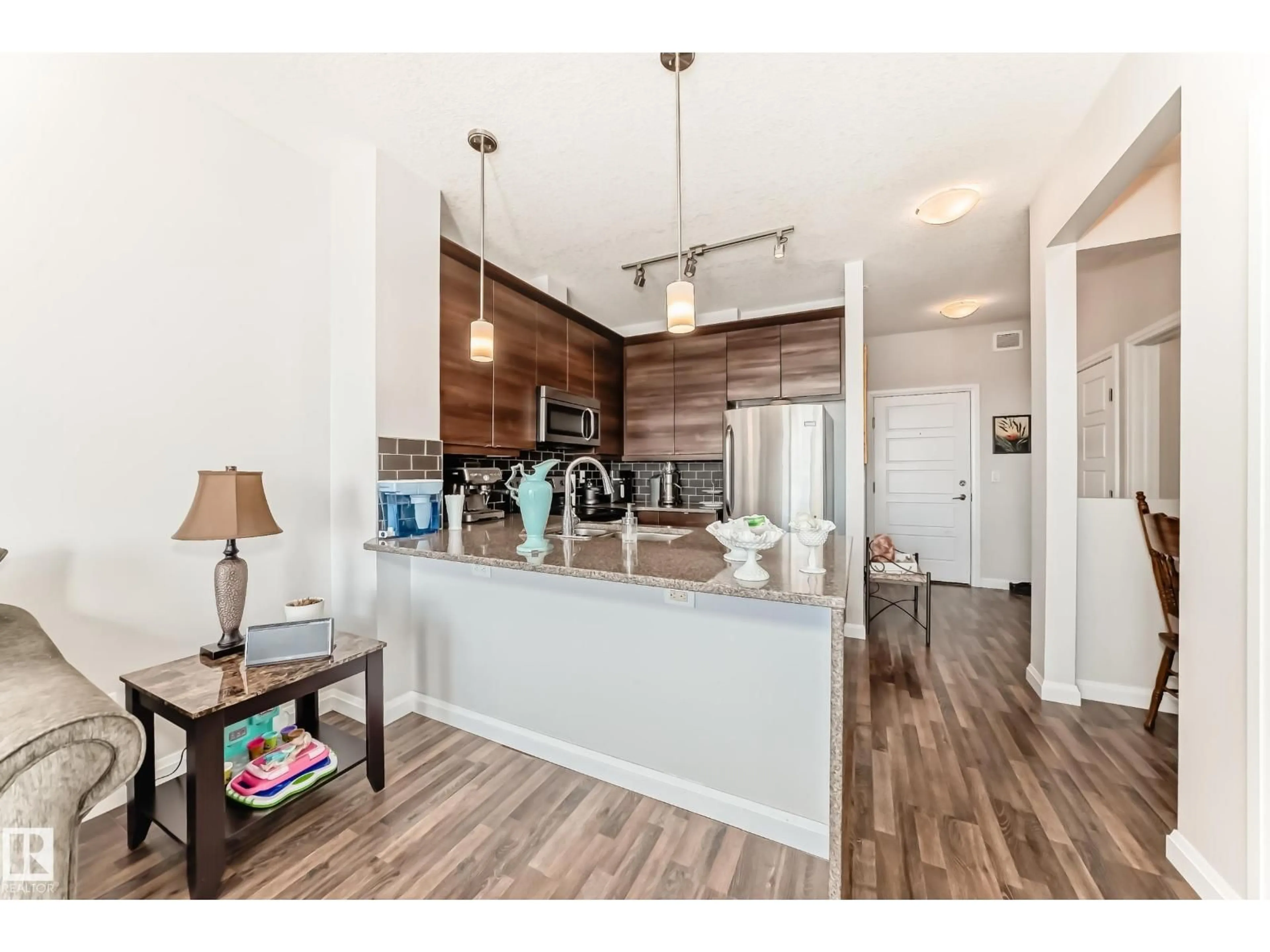 Open concept kitchen, wood/laminate floor for #406 - 2590 ANDERSON WY, Edmonton Alberta T6W0R2