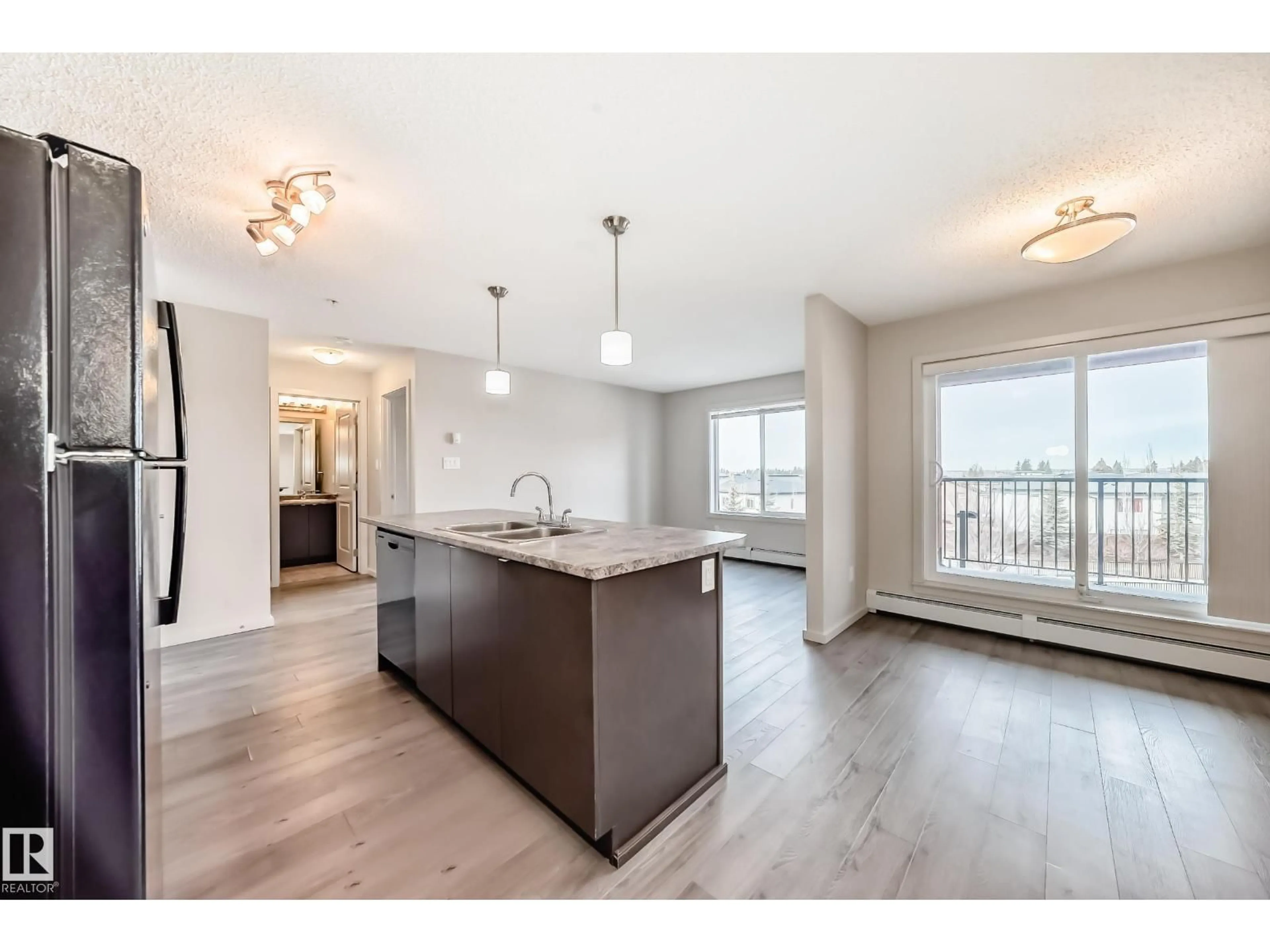 Open concept kitchen, wood/laminate floor for 332 - 344 WINDERMERE RD, Edmonton Alberta T6W2P2